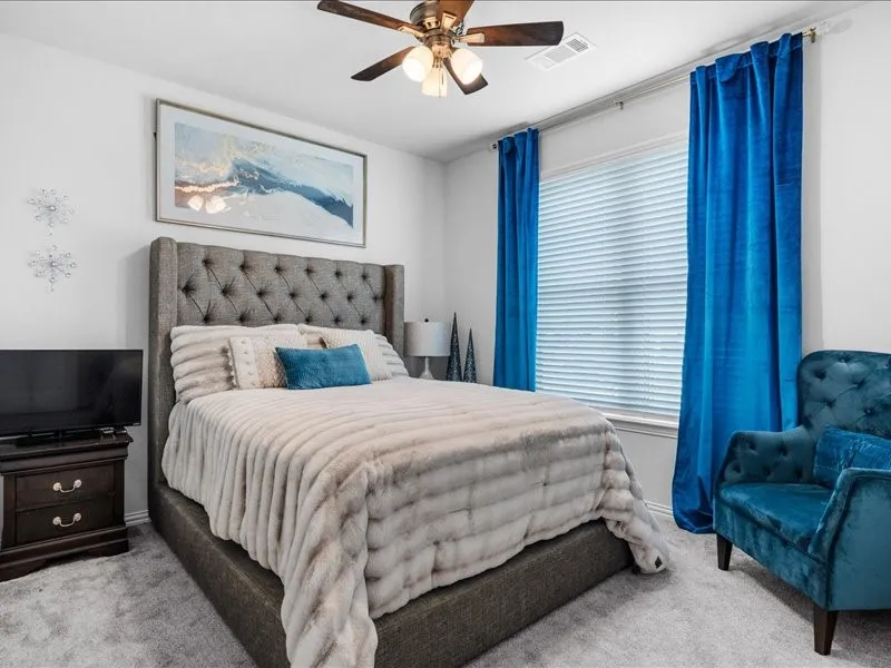 Recessed window with blinds, overhead ceiling fan with lighting, and light-toned wall paint