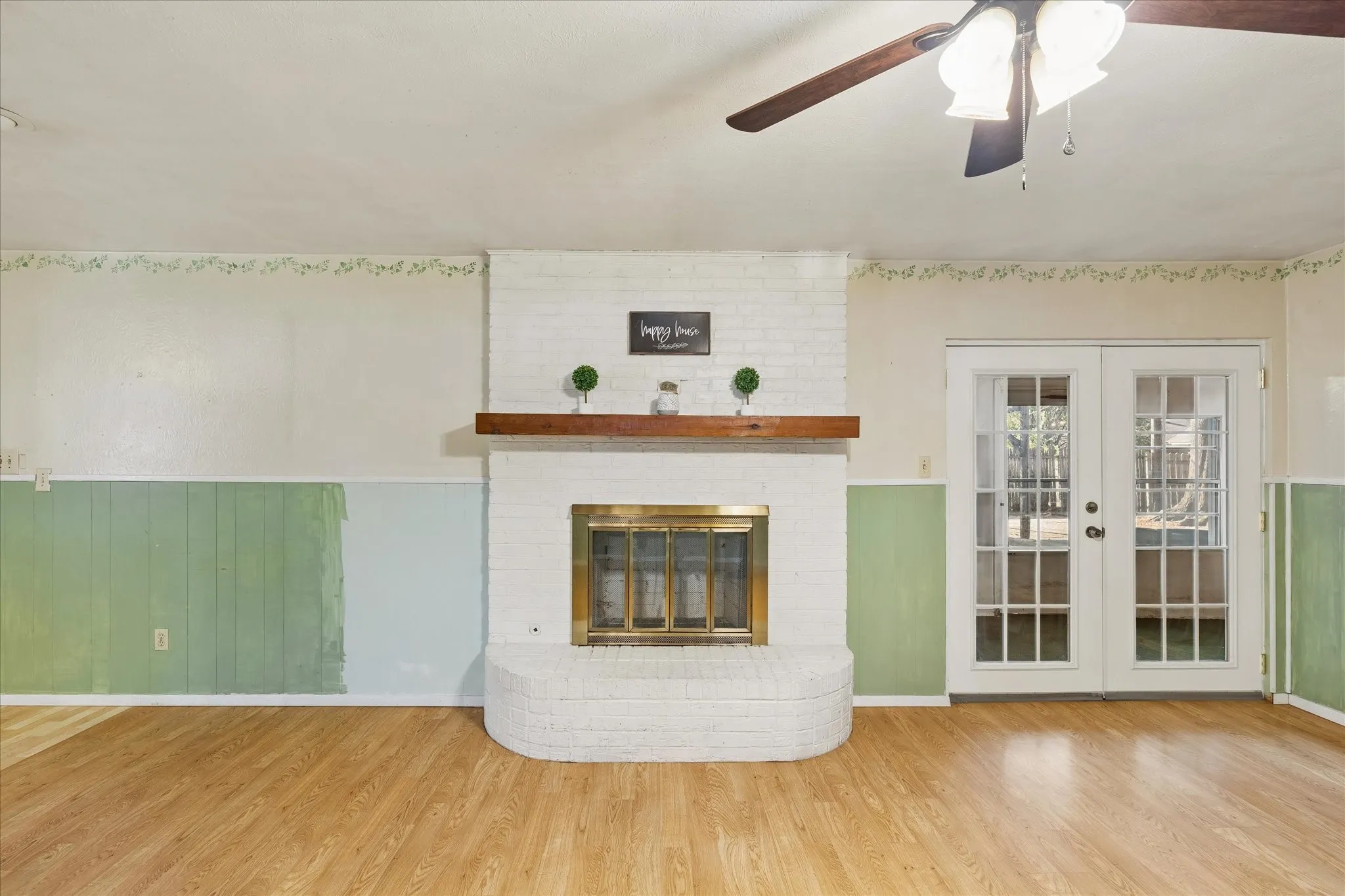 Brick Fireplace has gas starter & outlet above mantle for TV hookup