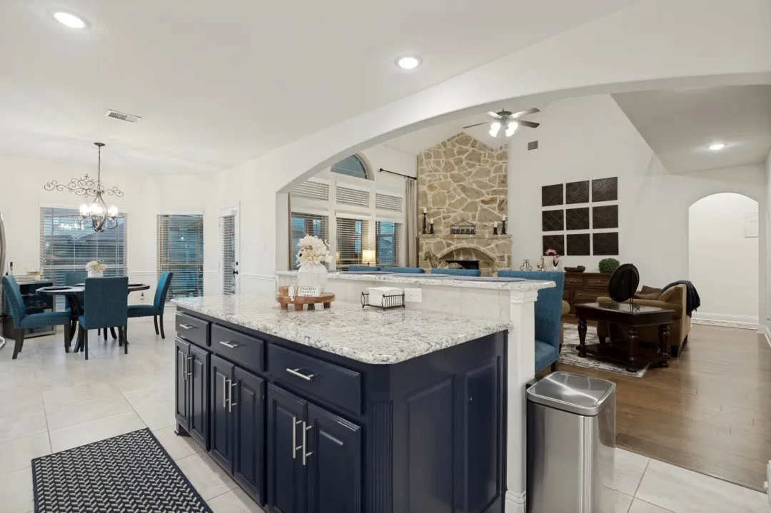 Kitchen island with dark cabinetry and light-toned countertop