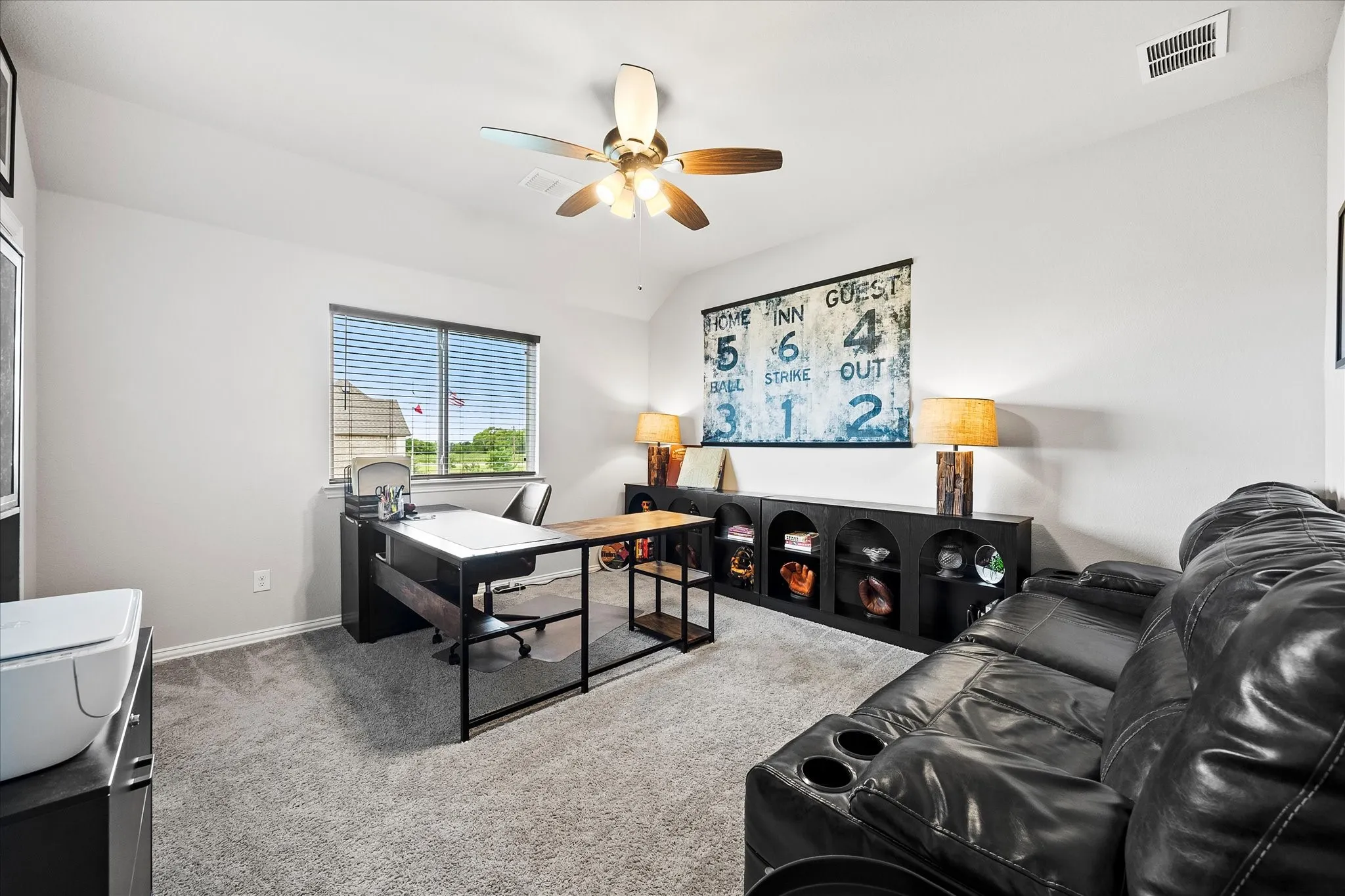5th bedroom used as an office space featuring a window with blinds, ceiling fan with integrated lighting