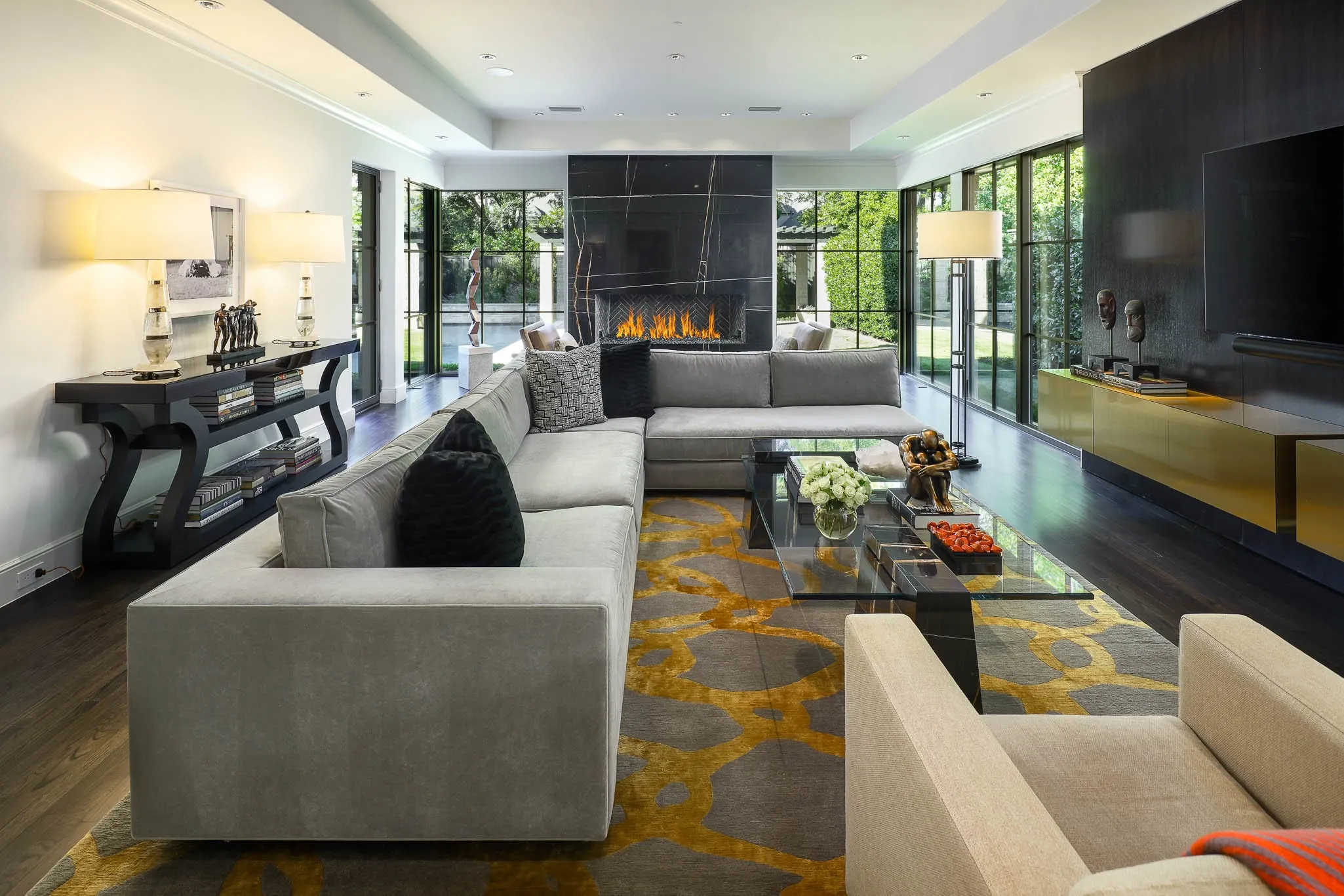 Family Room with gas fireplace with floor to ceiling windows overlooking private backyard