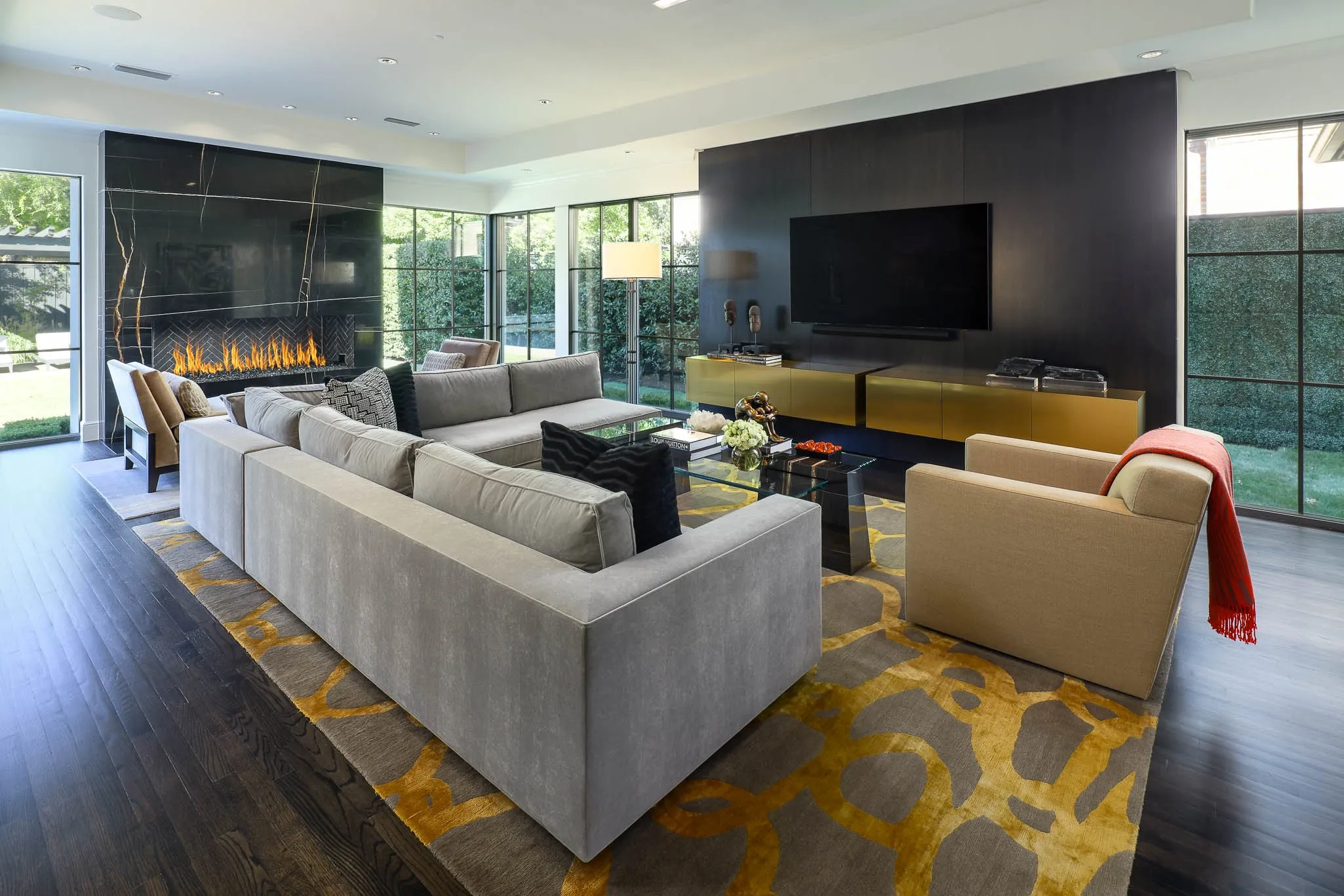 Family Room with gas fireplace and floor to ceiling windows overlooking backyard