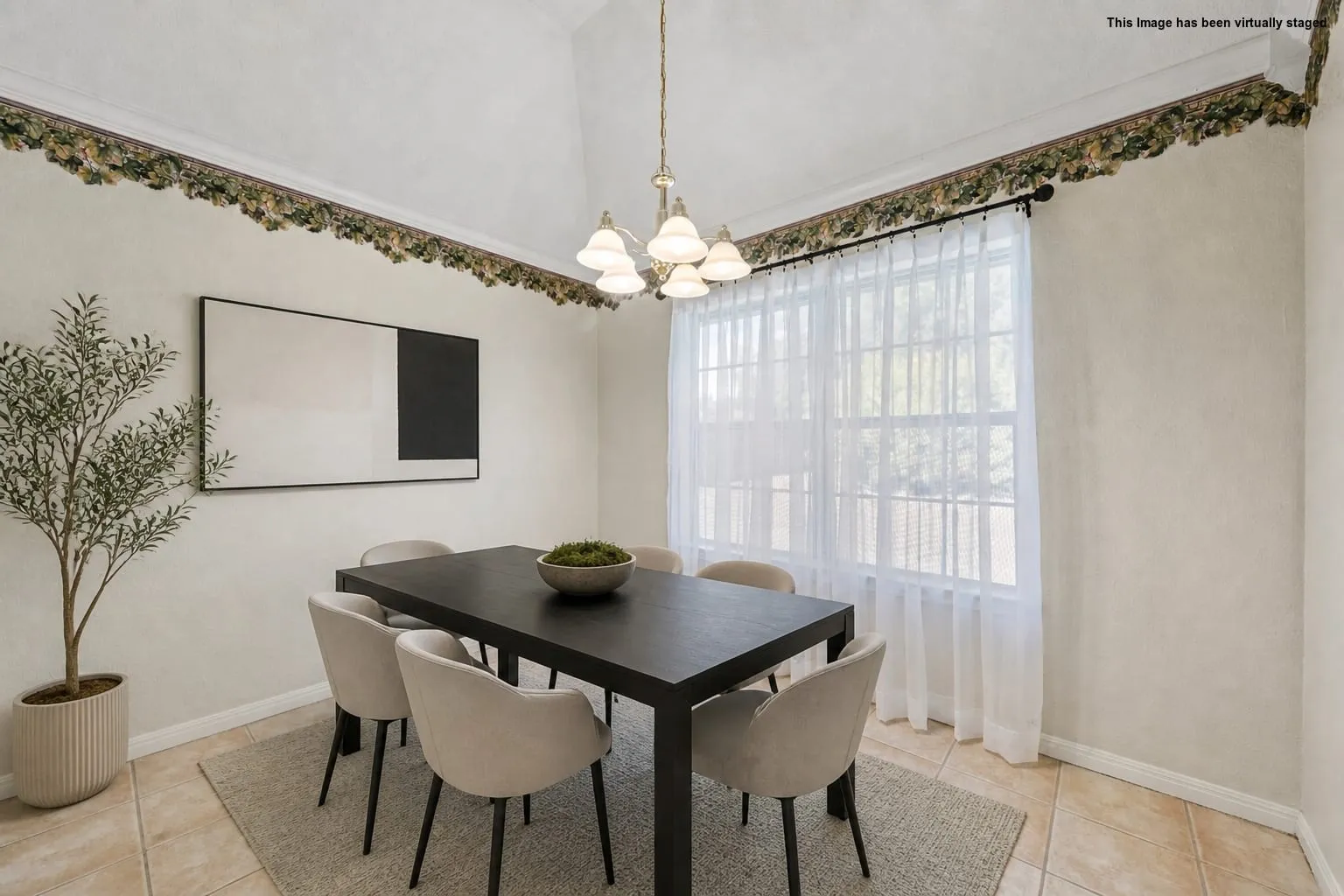 Vaulted ceiling, decorative wall trim, large window with sheers, pendant light fixture, and tile flooring