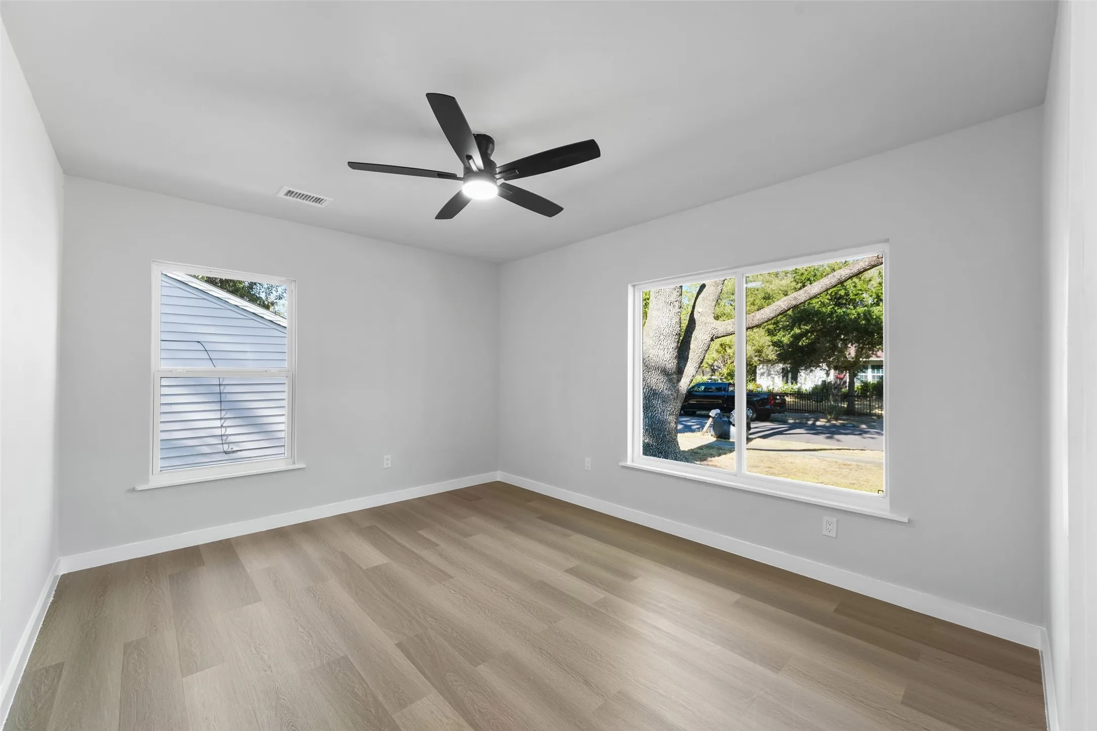 Recessed ceiling fan, wood-finish flooring, and multiple windows