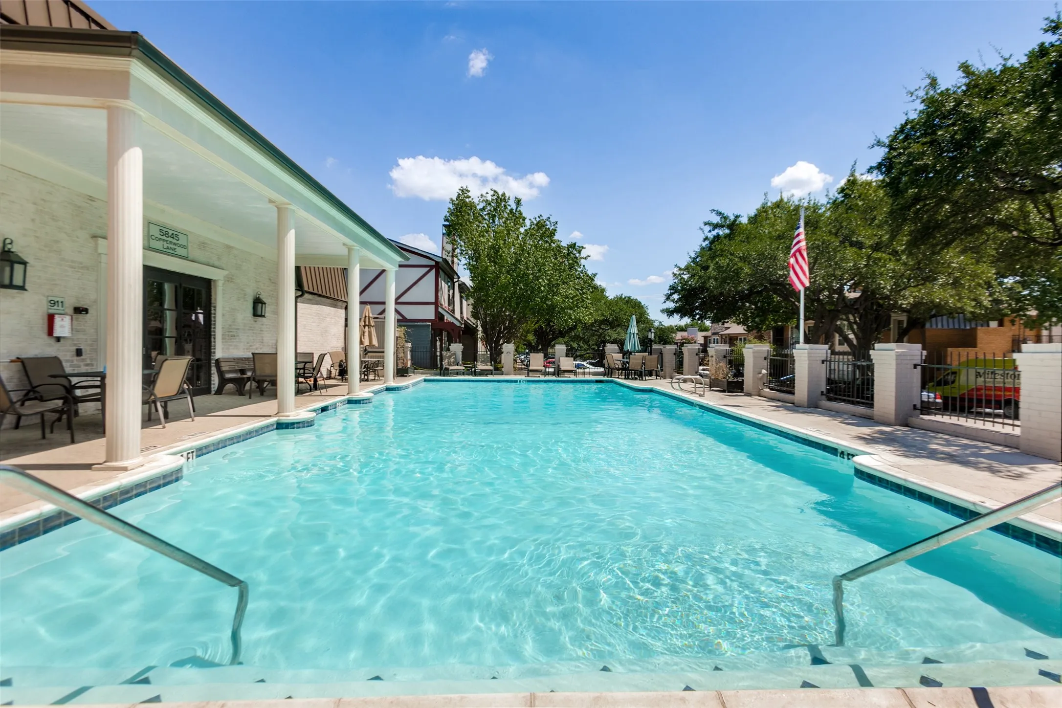 Expansive outdoor swimming pool with integrated entry steps and handrails
