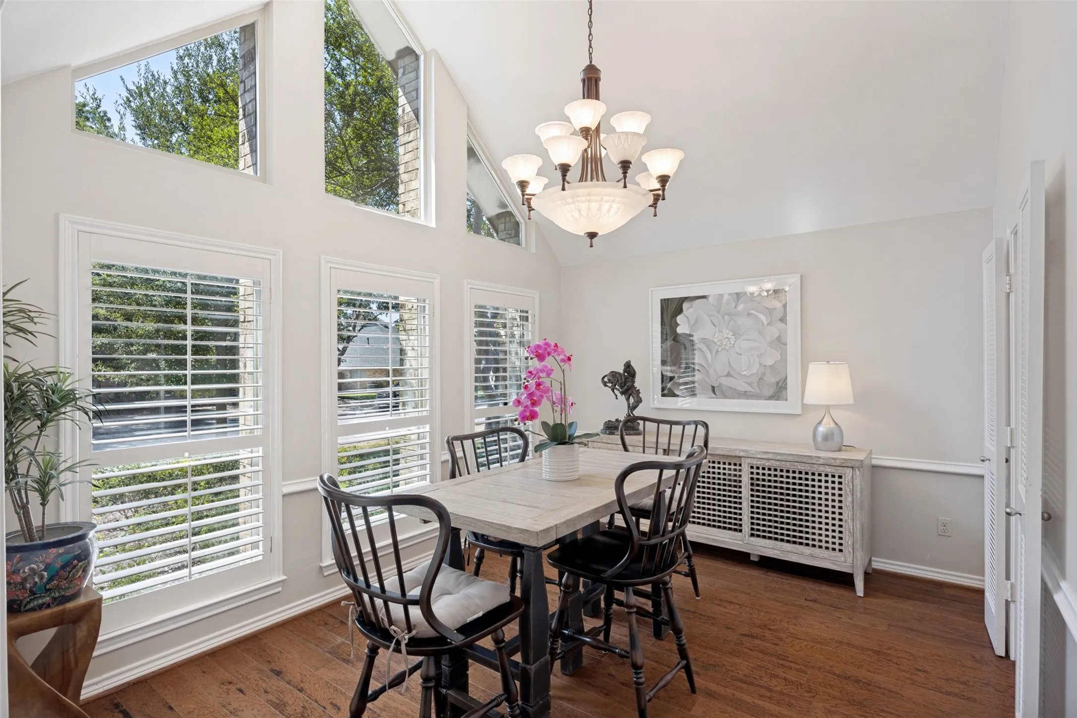 Light and bright with tall vaulted ceiling, plantation shutters and easy flow to the kitchen and living room for entertaining.