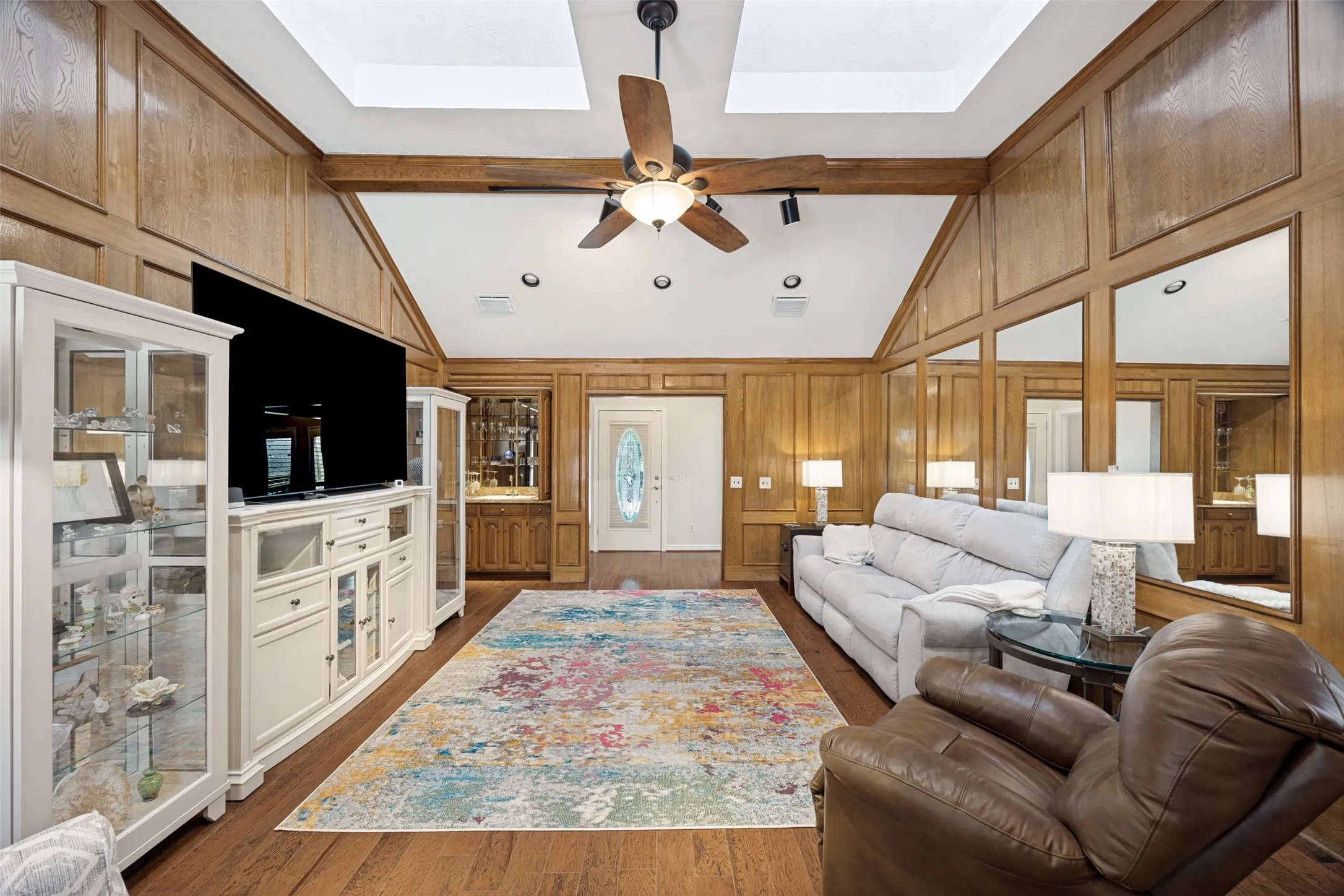 Hardwood floors and wood paneling add a warm ambiance.