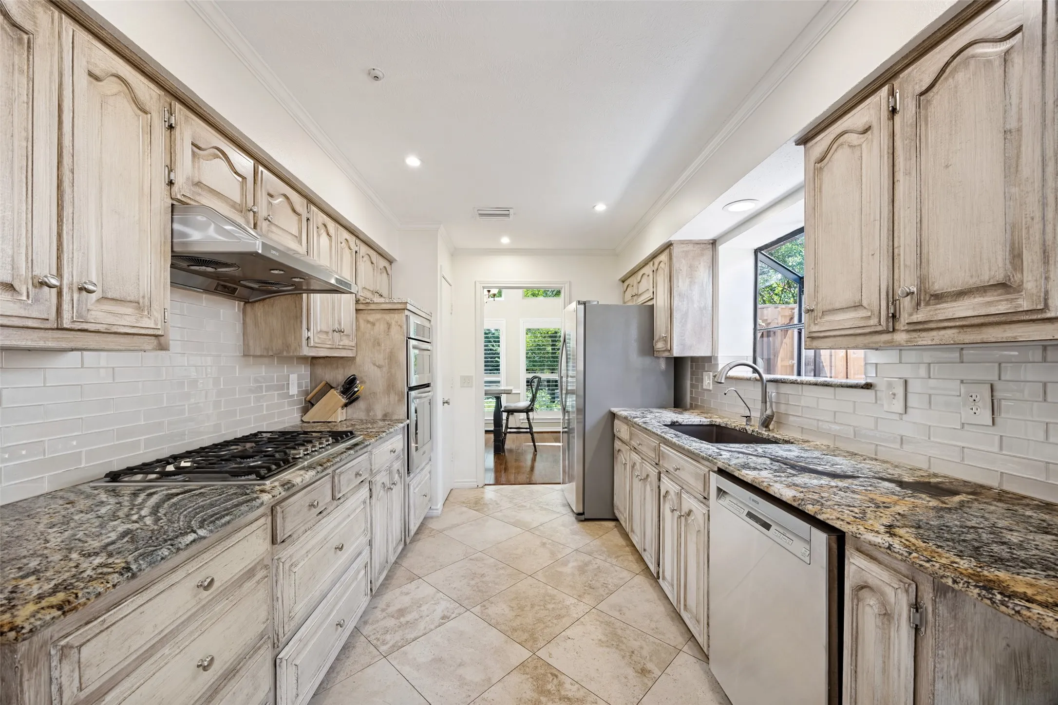 Granite surfaces, glass subway tile backsplash and tons of storage!