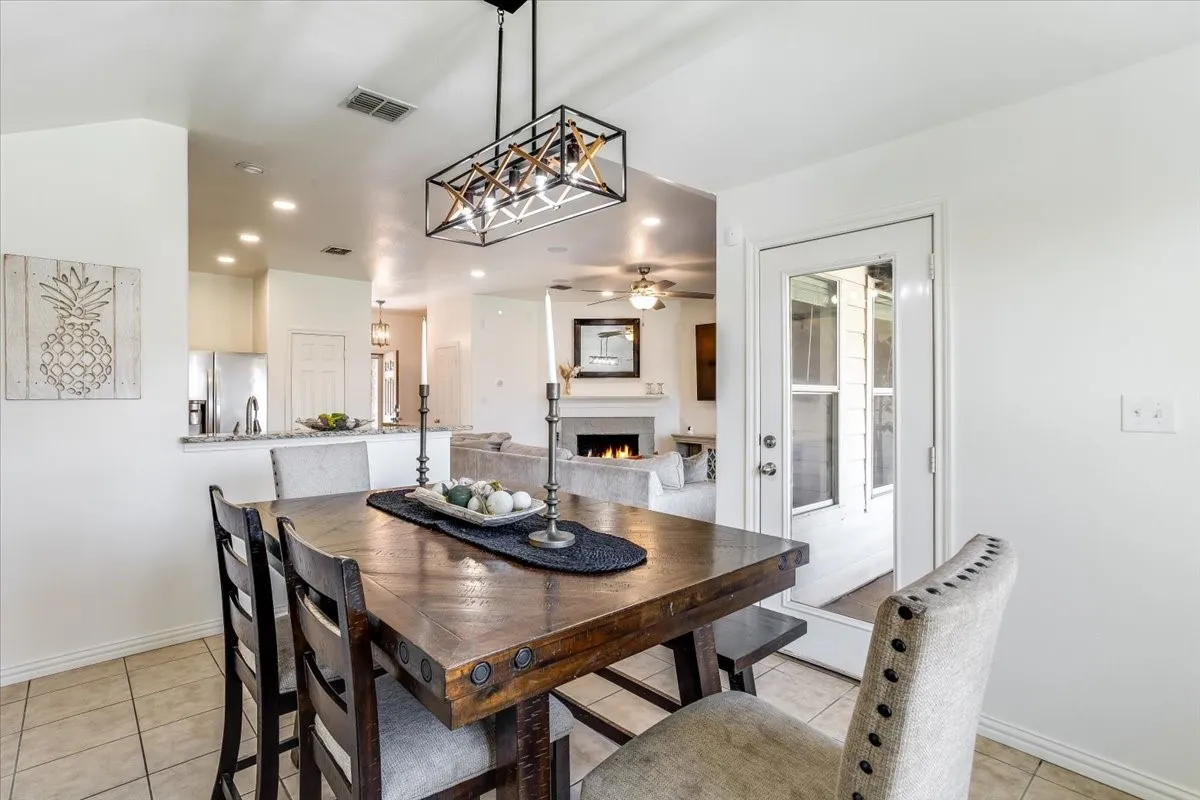 Dining area with tile flooring and a decorative chandelier