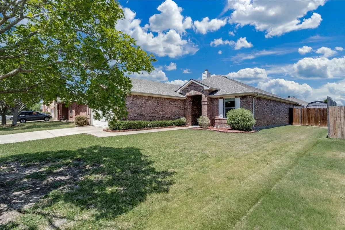 Brick exterior with white window shutters and a gabled roof