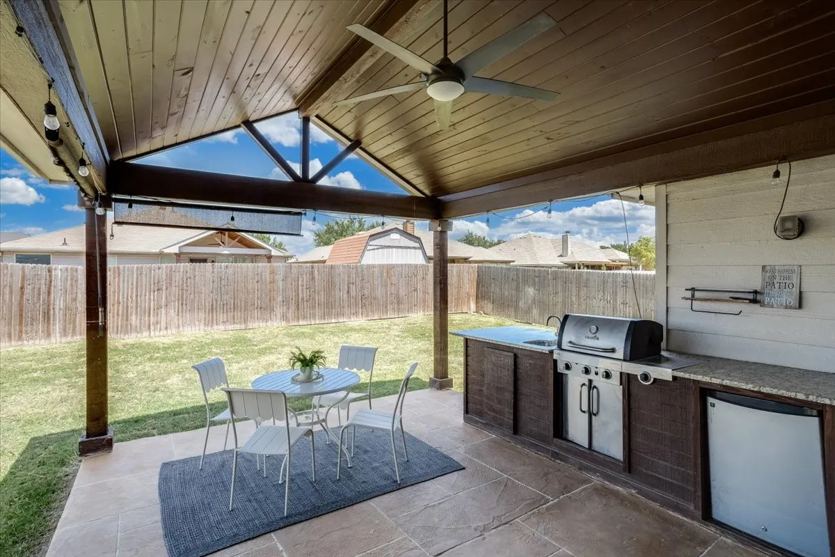 Covered patio featuring a wood-finish ceiling with exposed beams