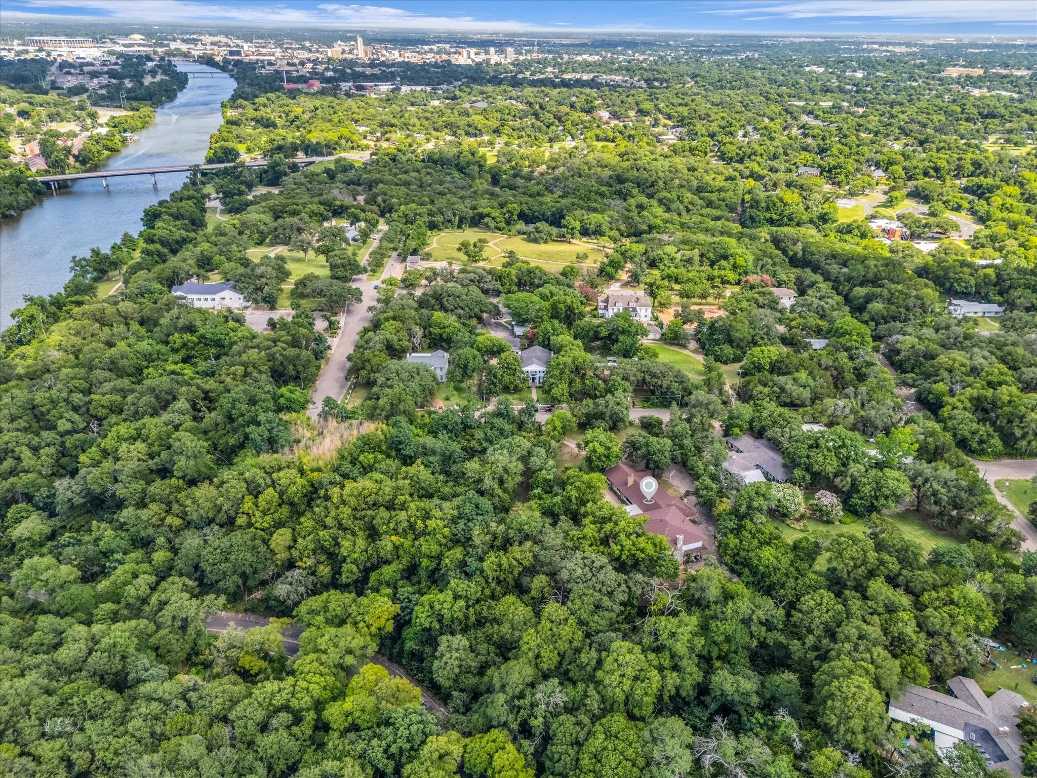 Expansive natural landscape featuring lush greenery and a riverfront setting