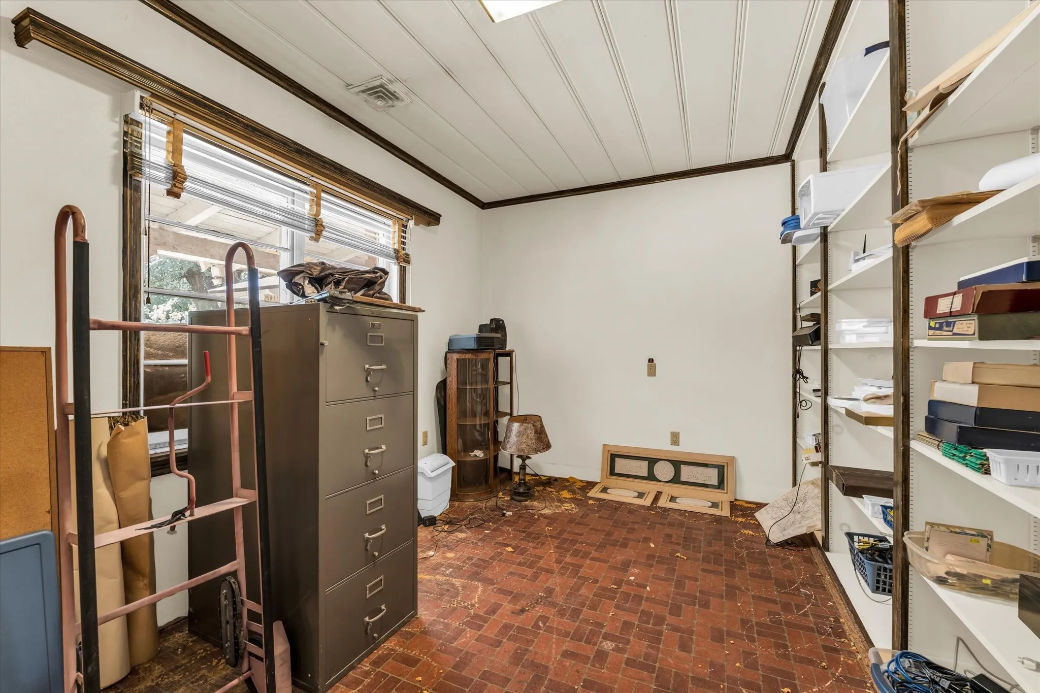 Beadboard ceiling with dark wood trim, large window, and built-in shelving