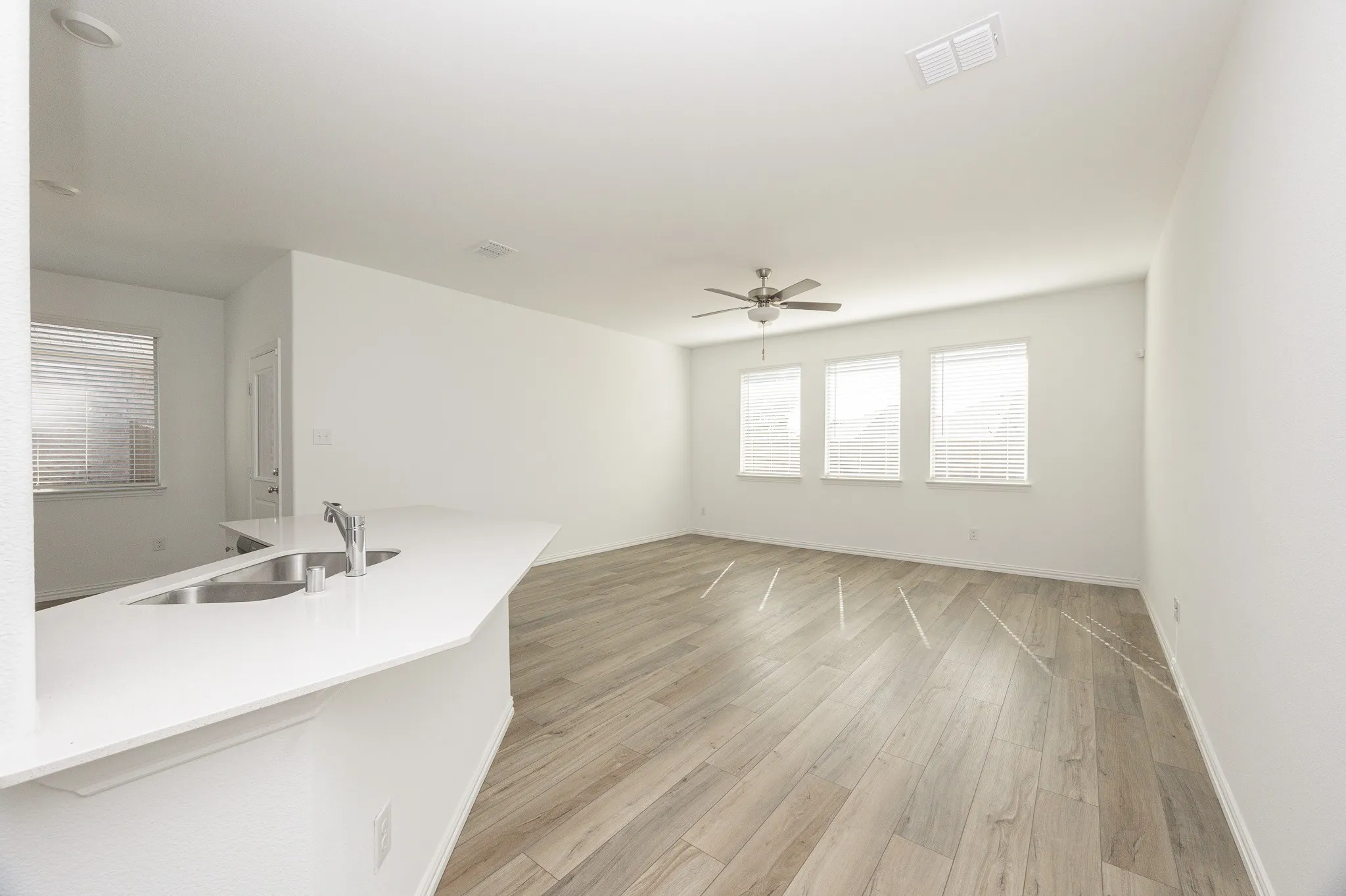 Open-concept common area featuring wood-finish flooring