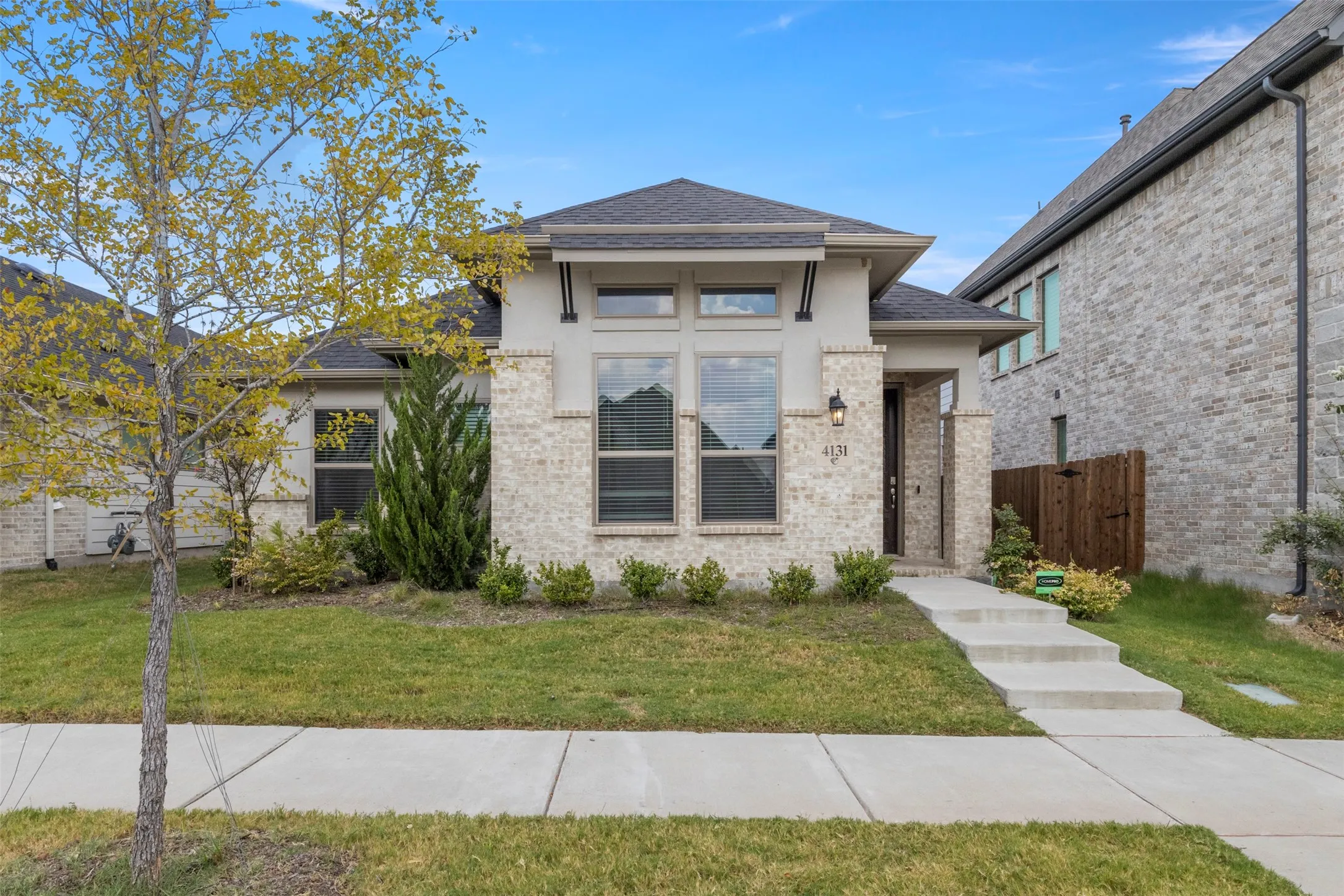 Contemporary single-story residence featuring a brick and stucco exterior