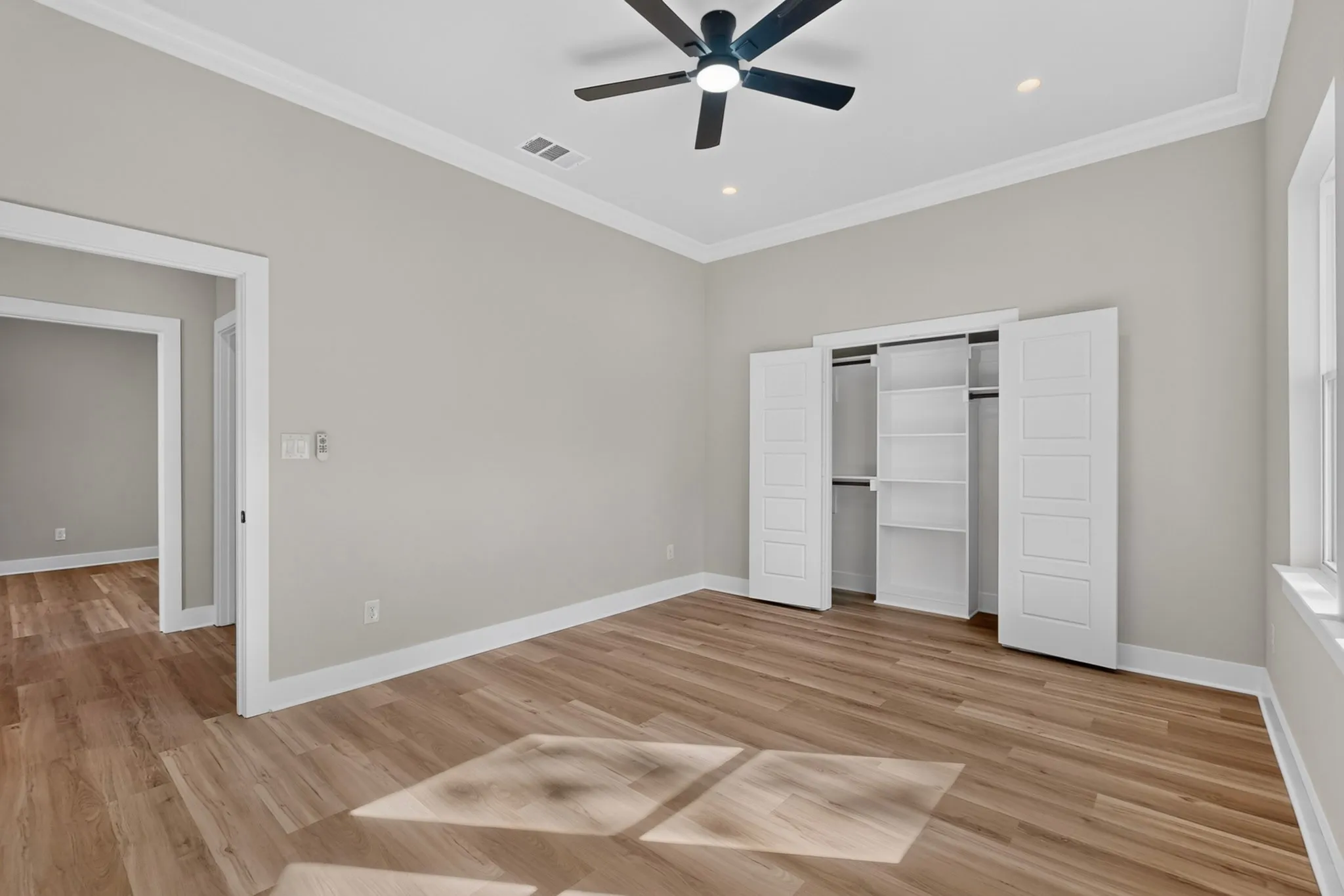 Light wood-finish flooring with white baseboards