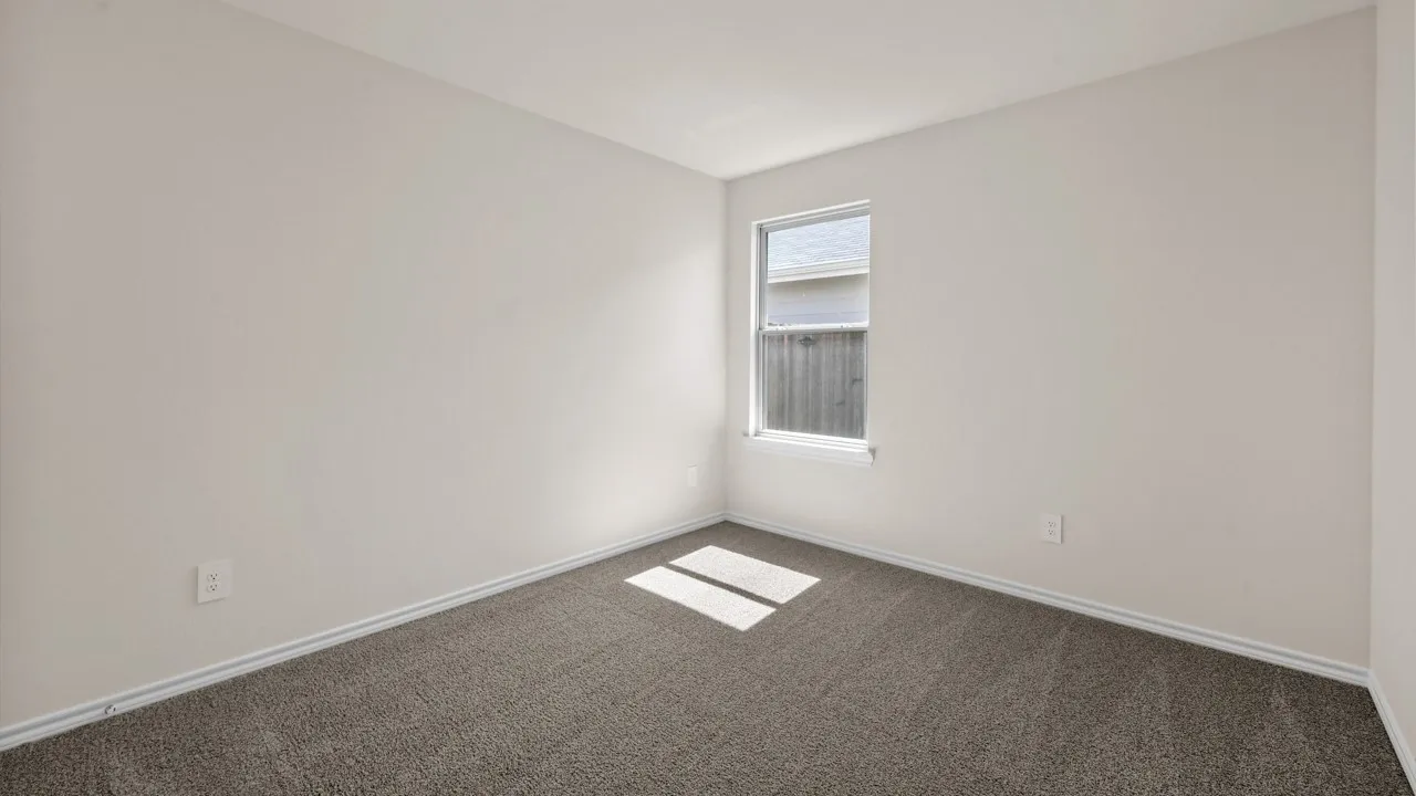 Neutral-toned walls, single-pane window, and carpeted flooring