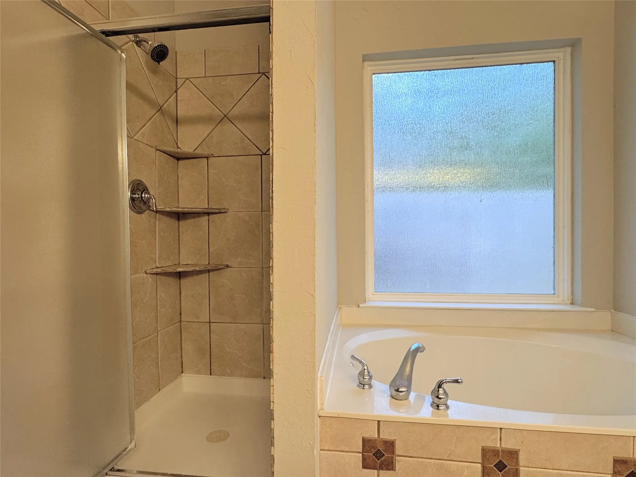 Primary bath has walk-in shower and garden tub