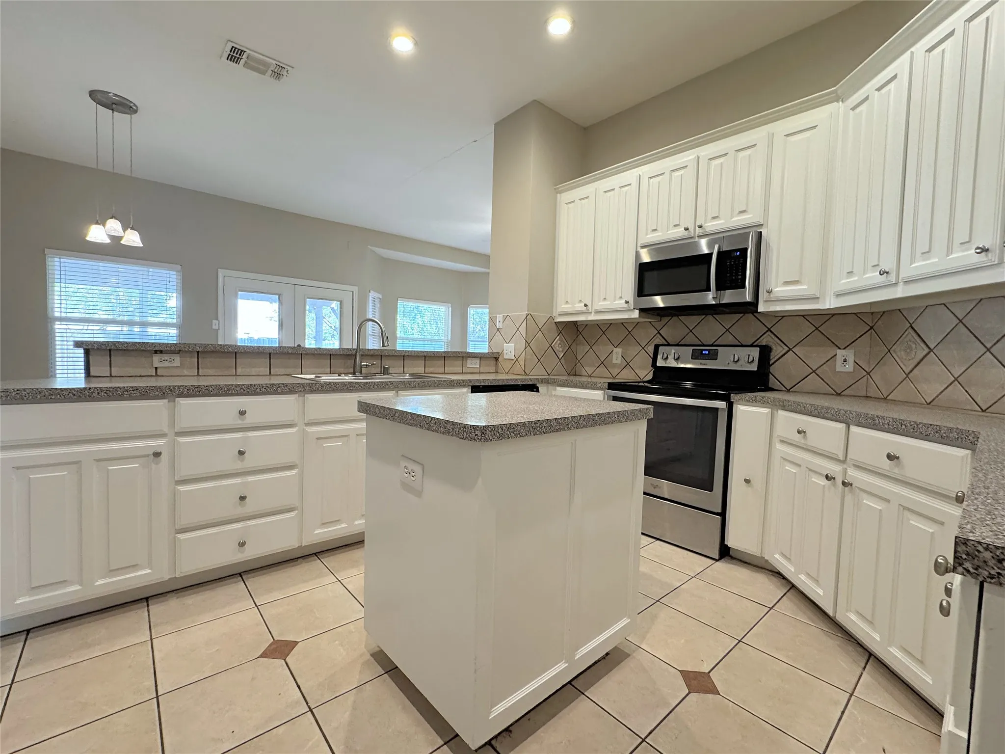 Kitchen has an electric range, microwave, and dishwasher