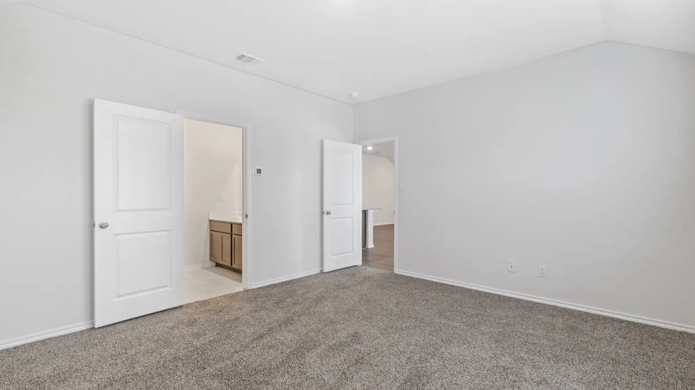 Vaulted ceiling, neutral wall tones, carpet flooring, paneled interior doors, and a double-door entry