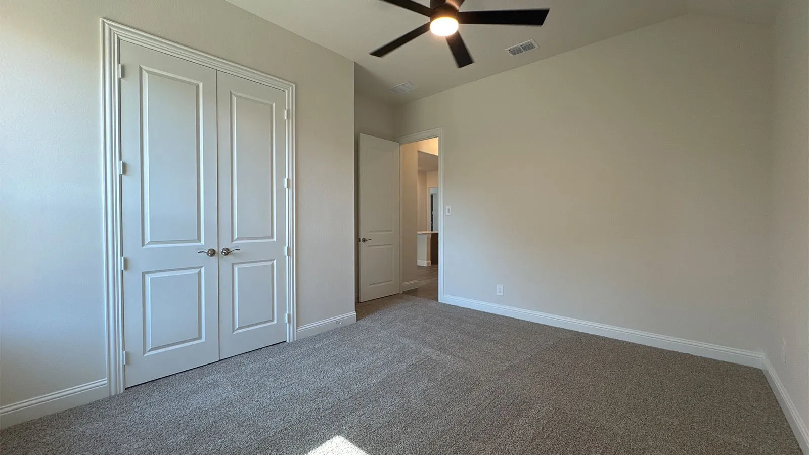 Textured wall finishes, vaulted ceiling, and carpeted flooring