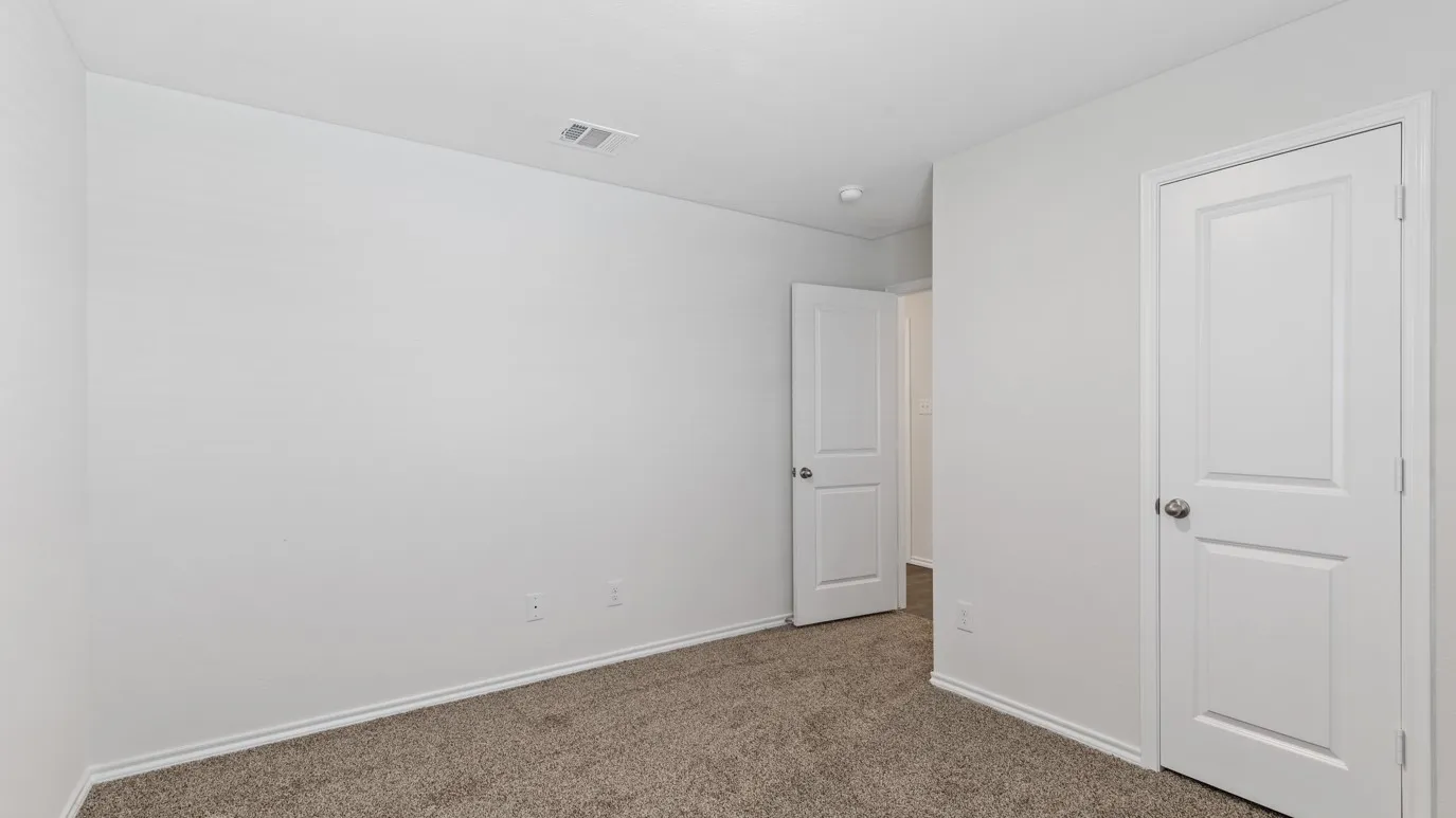 Neutral wall paint and plush carpet flooring
