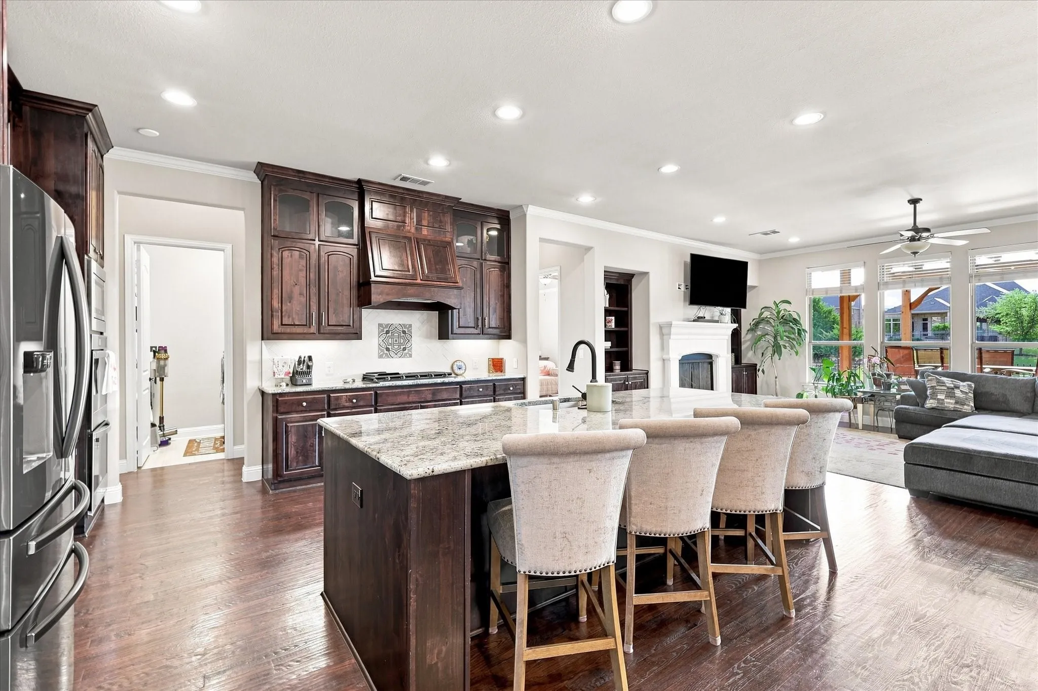 Double ovens, a gas cooktop, and breakfast bar seating
