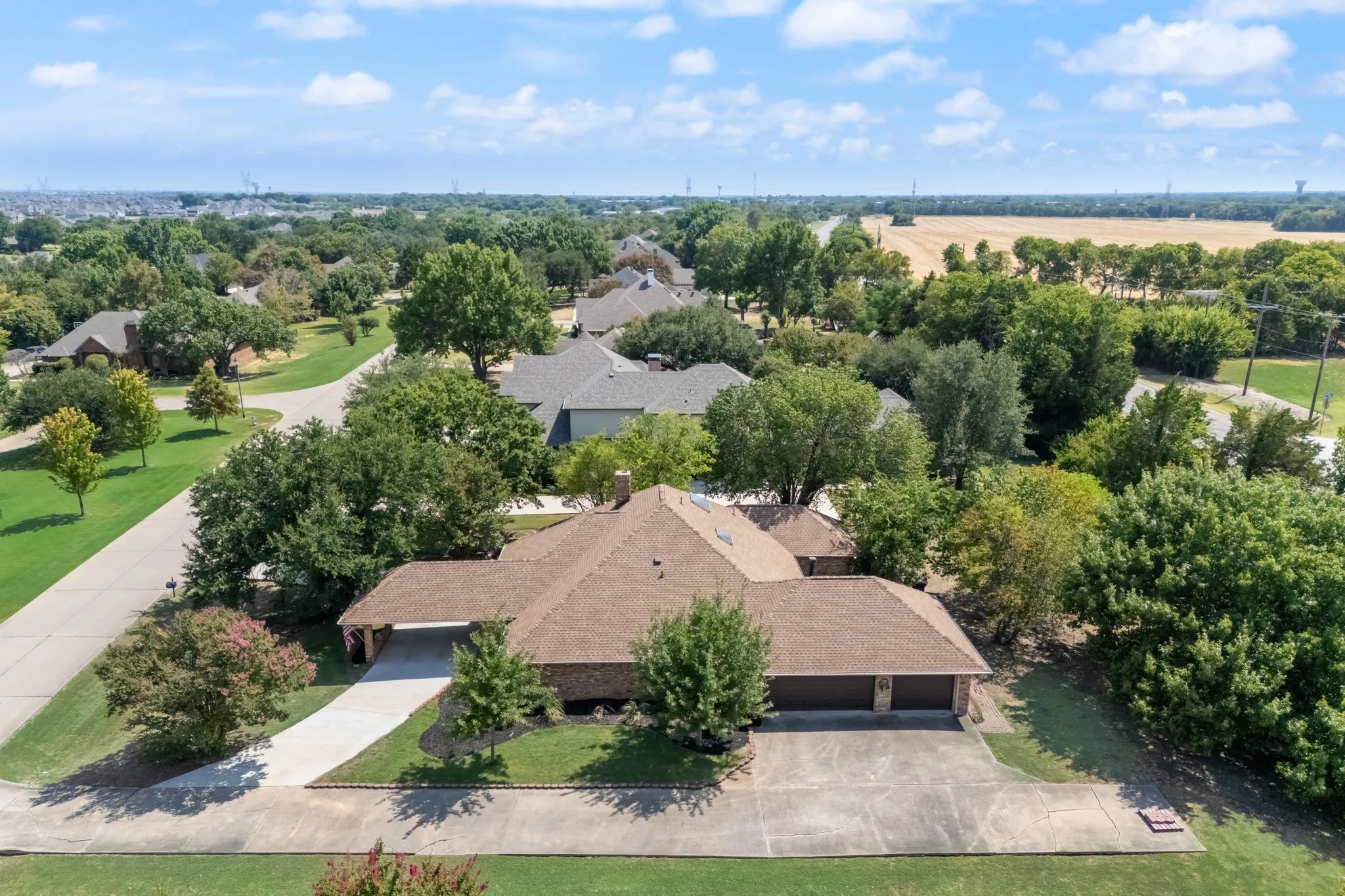 Traditional architectural style featuring a Level 4 roof, attached three-car garage with plenty of parking space!