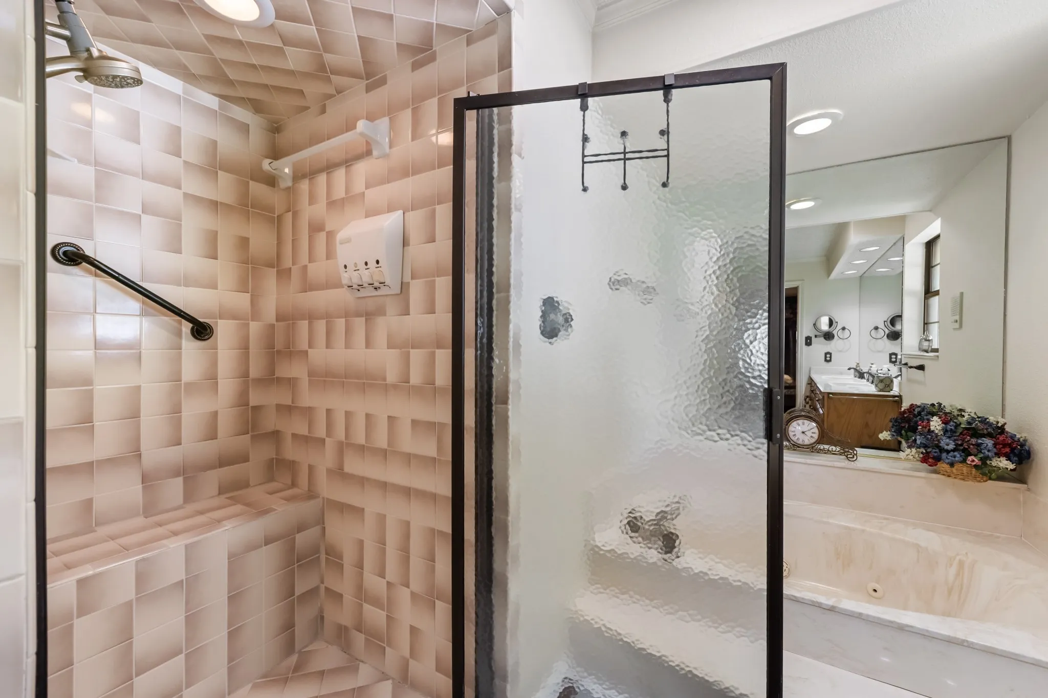 Shower enclosure with textured glass, tiled walls, built-in shower bench