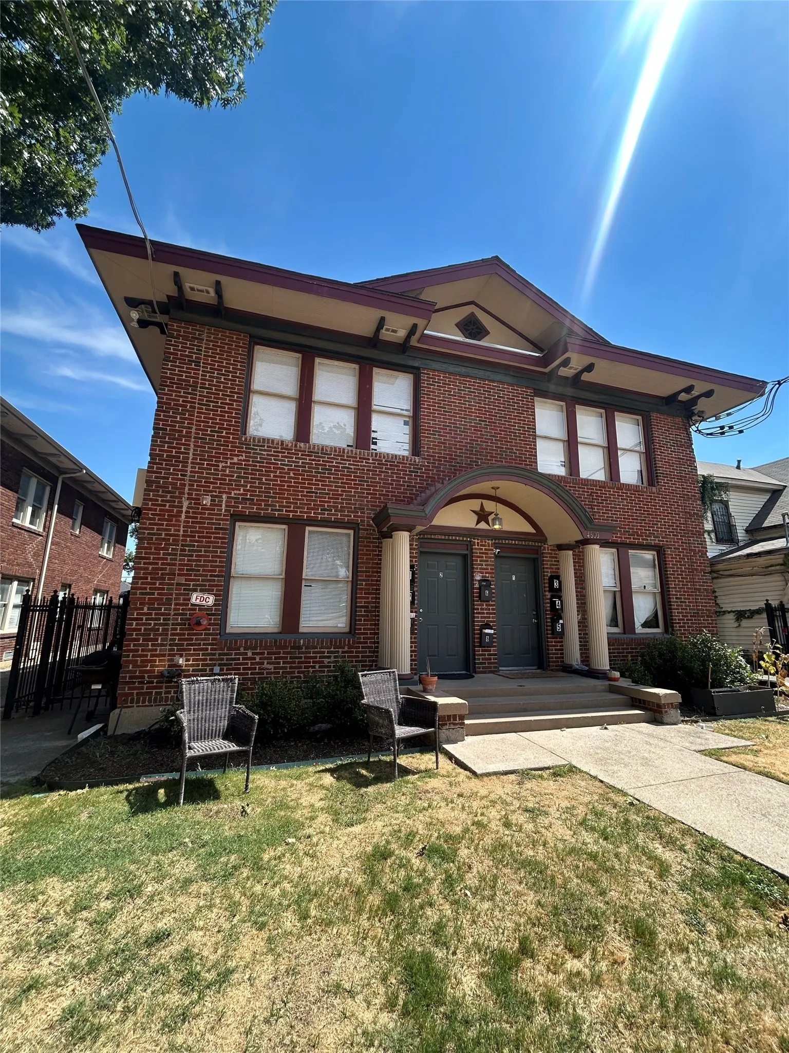 Brick exterior with architectural corbels, multiple entryways, and a symmetrical facade