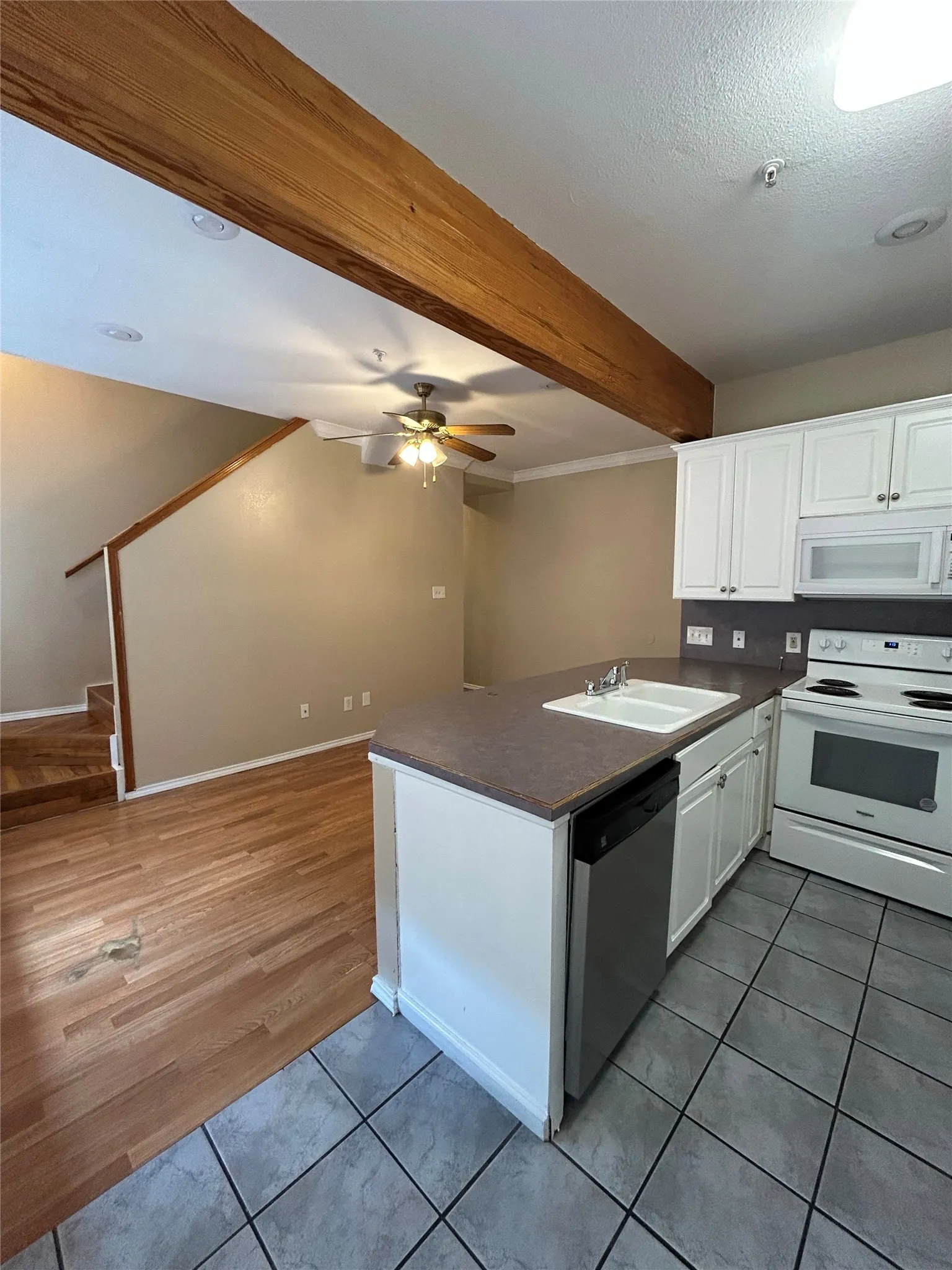 Open-concept kitchen with white cabinetry and a breakfast bar