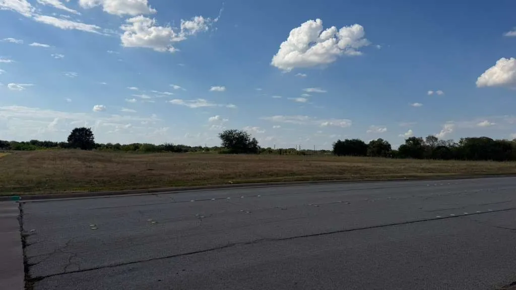 Expansive undeveloped land featuring natural vegetation and scattered trees