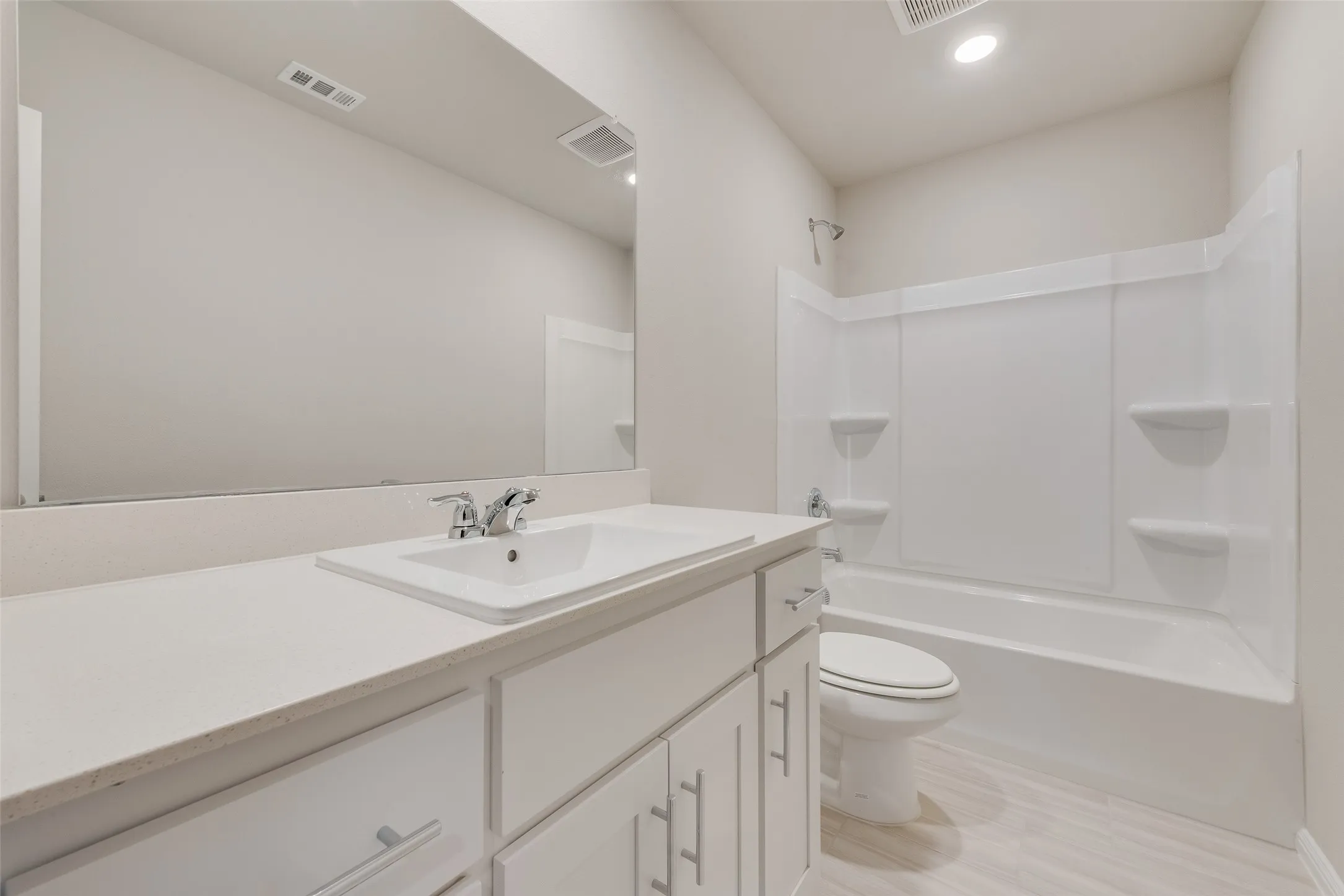 White vanity with brushed nickel hardware, square undermount sink, and light countertop