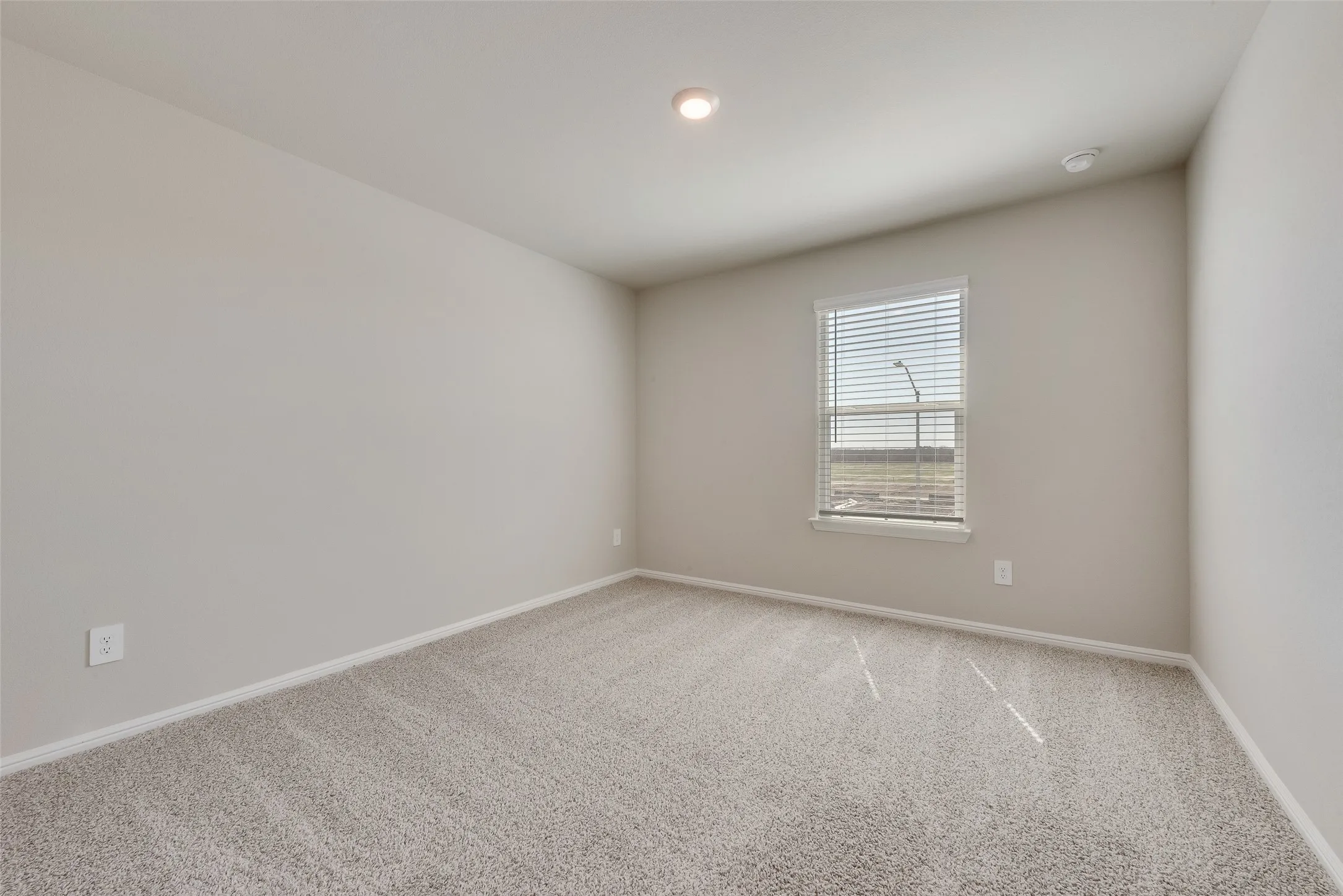 Neutral-toned walls with recessed lighting
