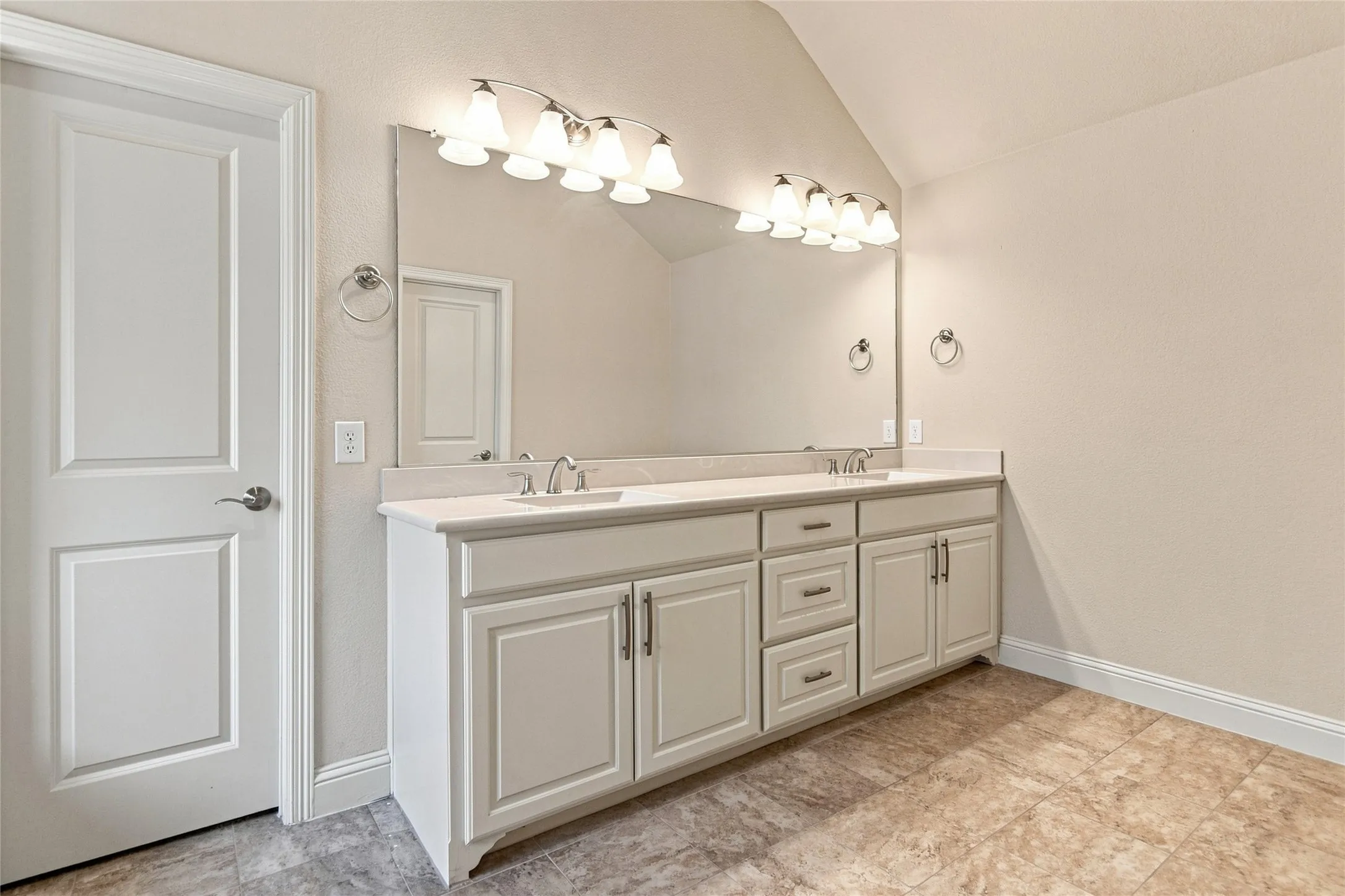 Dual vanity with undermount sinks, stone-finish countertop, and brushed nickel fixtures