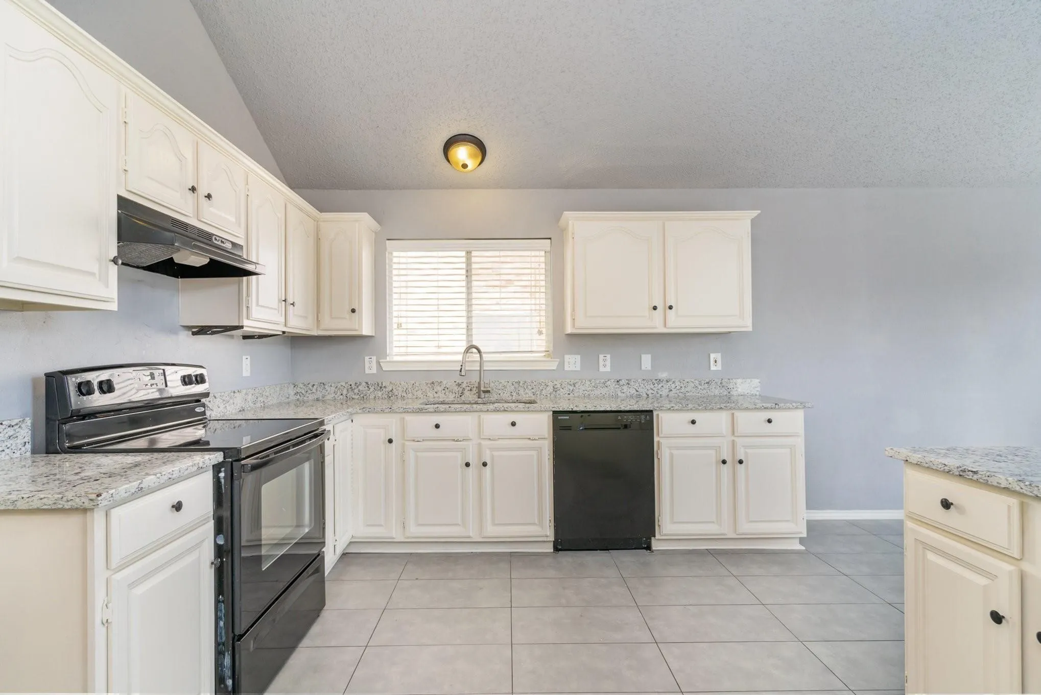 White cabinetry, speckled countertops, stainless steel sink, black electric range, and black dishwasher