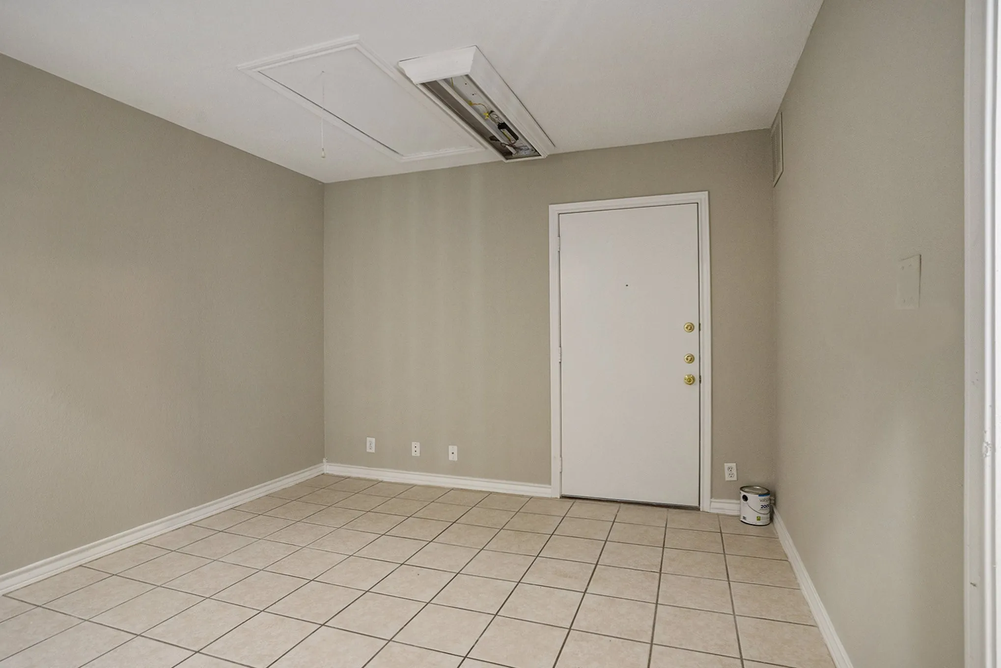 Light-toned tile flooring, neutral wall paint, and white trim throughout