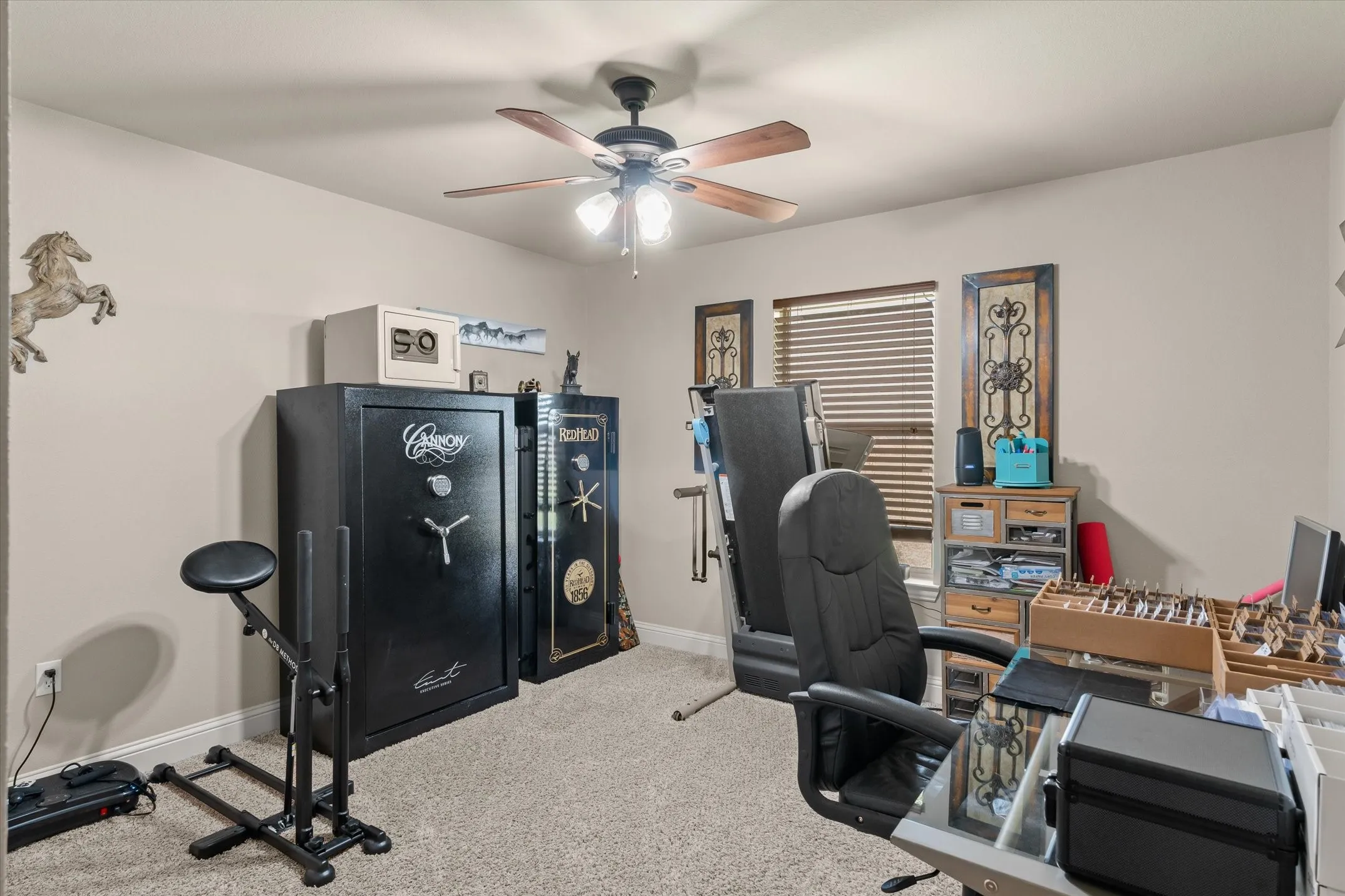 Textured carpeting, neutral wall tones, and a ceiling fan with light fixture