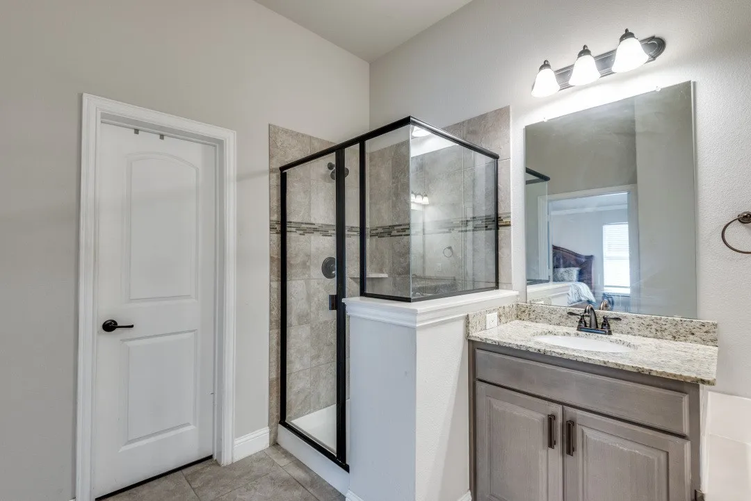 Walk-in shower with tiled surround and glass enclosure