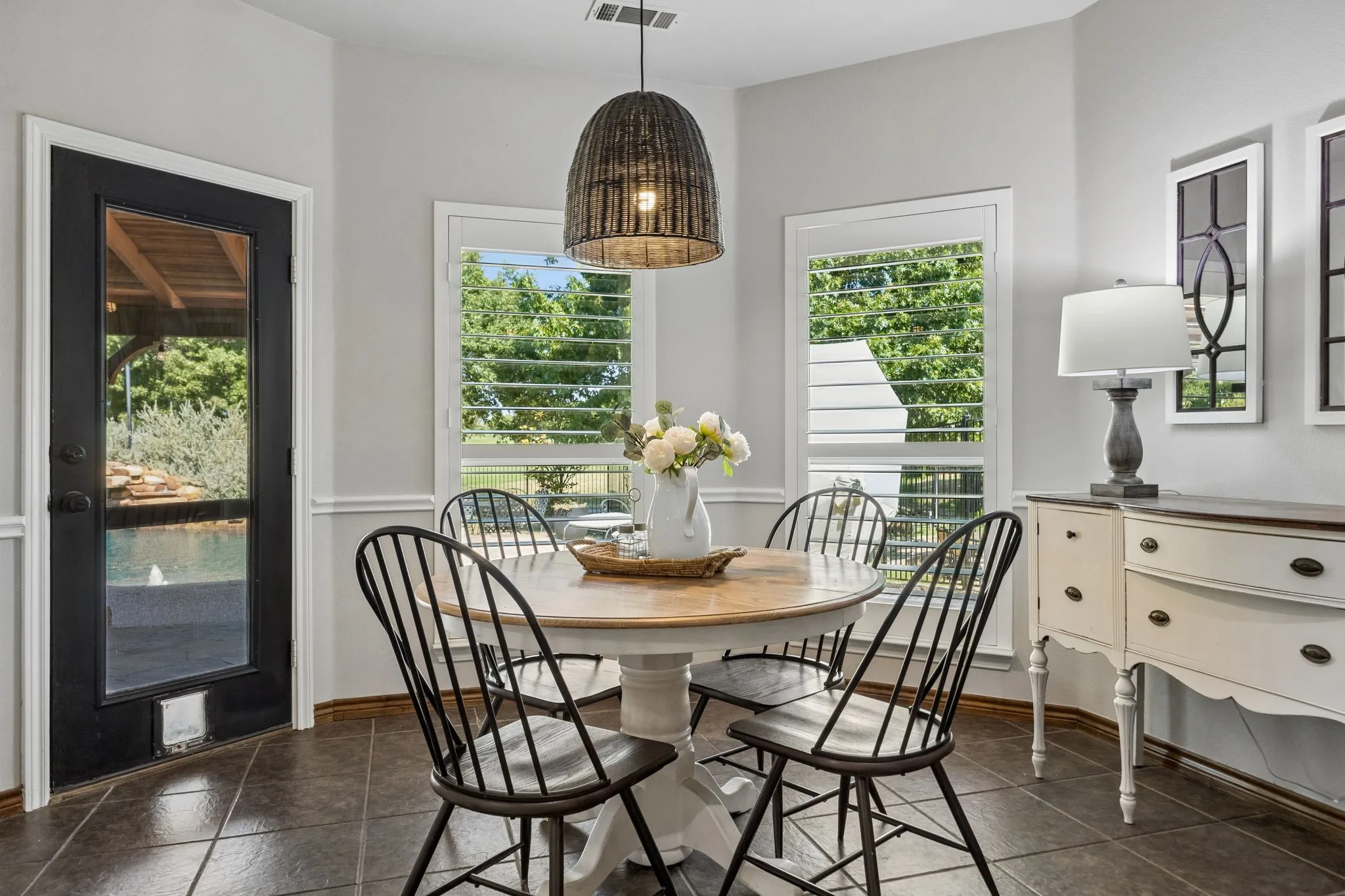 Breakfast with a Backyard View - The casual dining area sits beside windows overlooking the pool and backyard, creating an inviting spot for morning coffee, everyday meals and conversation.