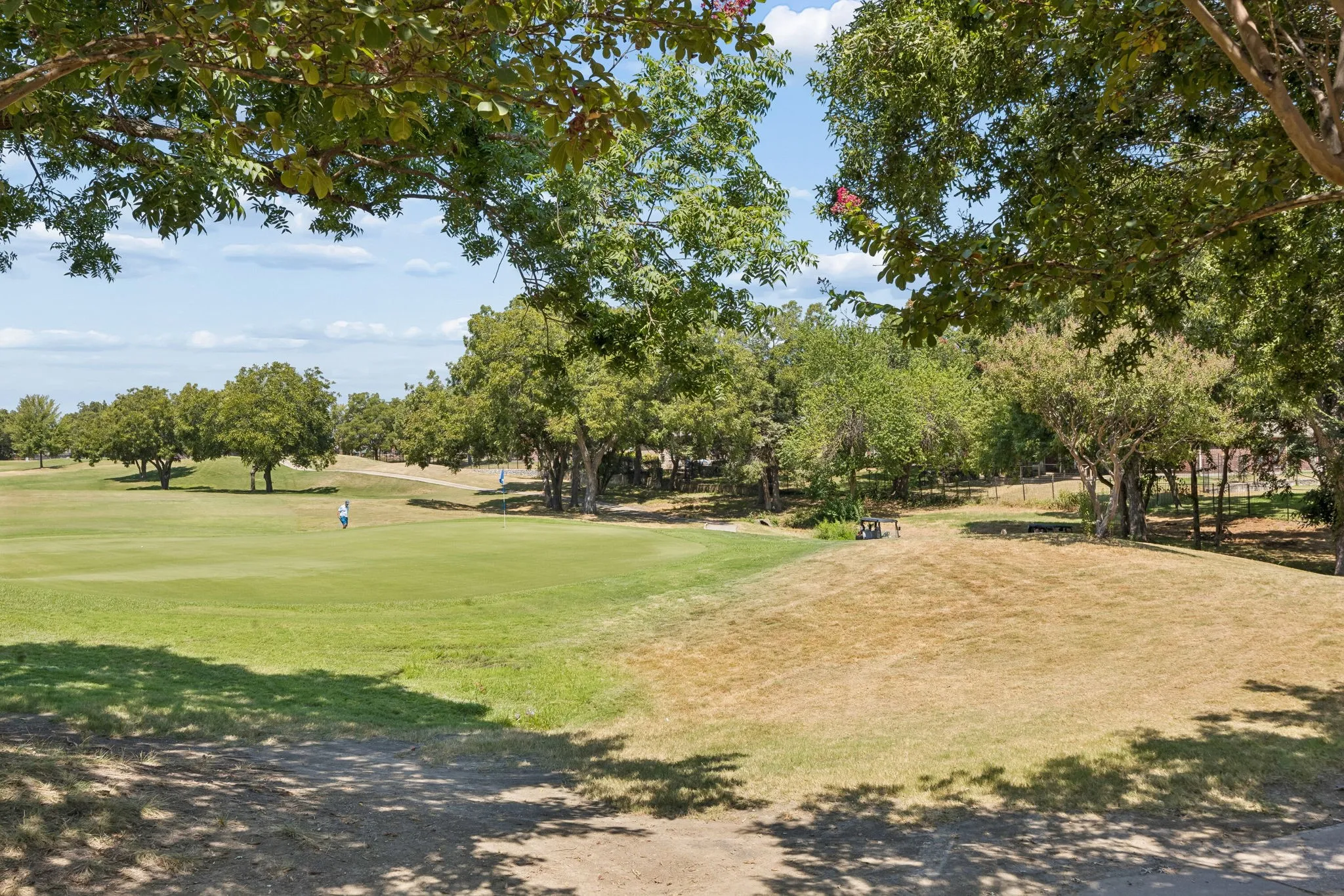 Right on the #4 Green - The backyard opens directly to the #4 green of Waterview Golf Course, giving the property an unusually close connection to the course and a long view down the fairway.