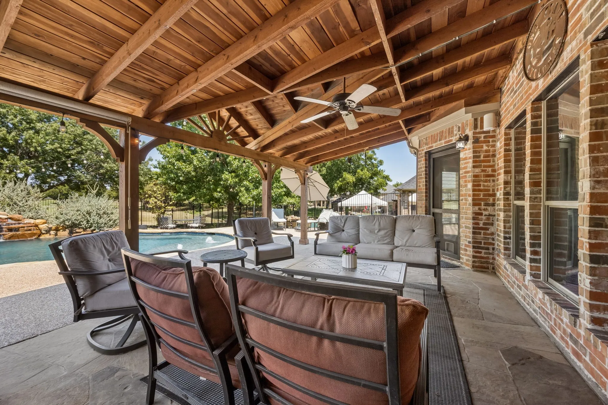 Built for Long Afternoons Outside - Generous covered space provides plenty of room to relax or entertain out of the Texas sun, while the open design keeps the pool and backyard within view.
