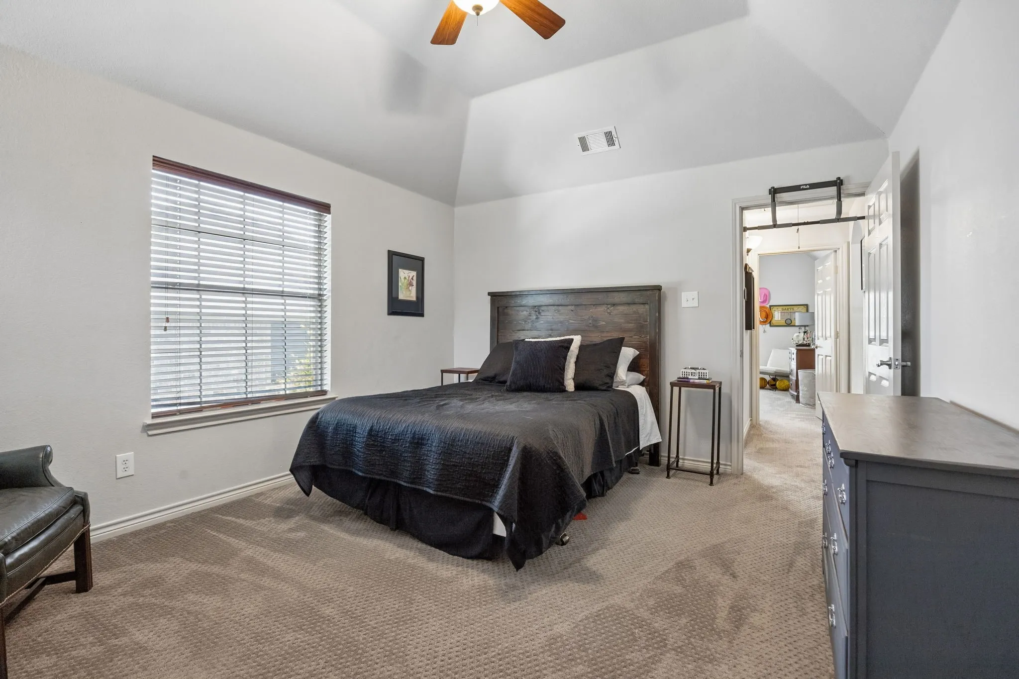 More Than Just a Place to Sleep - This generously sized secondary bedroom provides room for larger furnishings and additional seating or workspace, while the elevated ceiling enhances the sense of space.