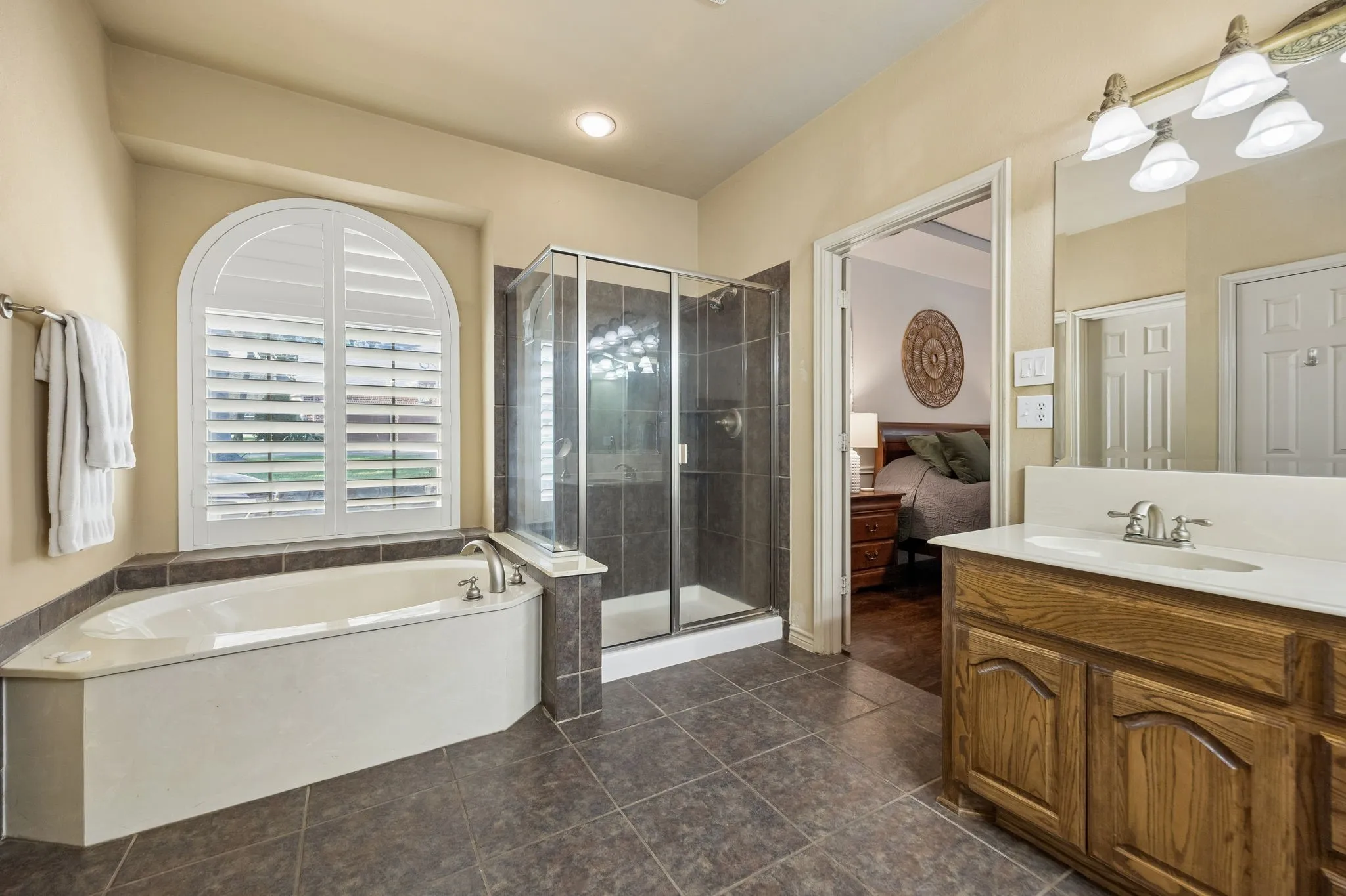 Separate Tub and Shower - The primary bath features a large soaking tub and separate glass-enclosed shower, creating distinct spaces for a quick start to the day or a slower end to it.