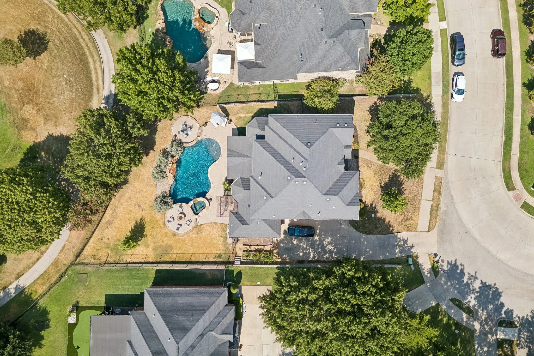 A Lot That Sets This Home Apart - From above, the over-one-third-acre homesite reveals just how much outdoor space surrounds the home, with a pool, spa, multiple gathering areas and direct frontage along the golf course.