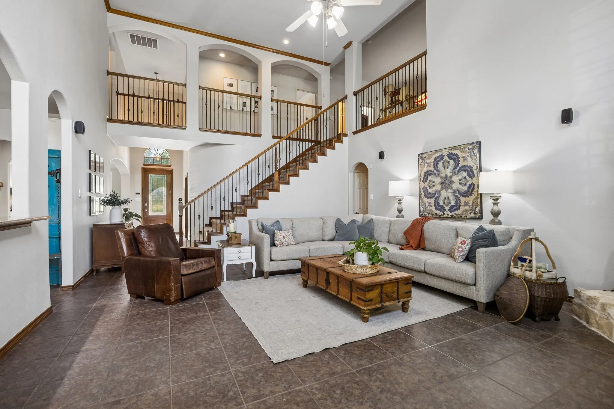 Open, Airy and Connected - The two-story family room feels expansive without being isolated, with the staircase and upstairs gallery overlooking the living space and creating an easy connection between both levels of the home.