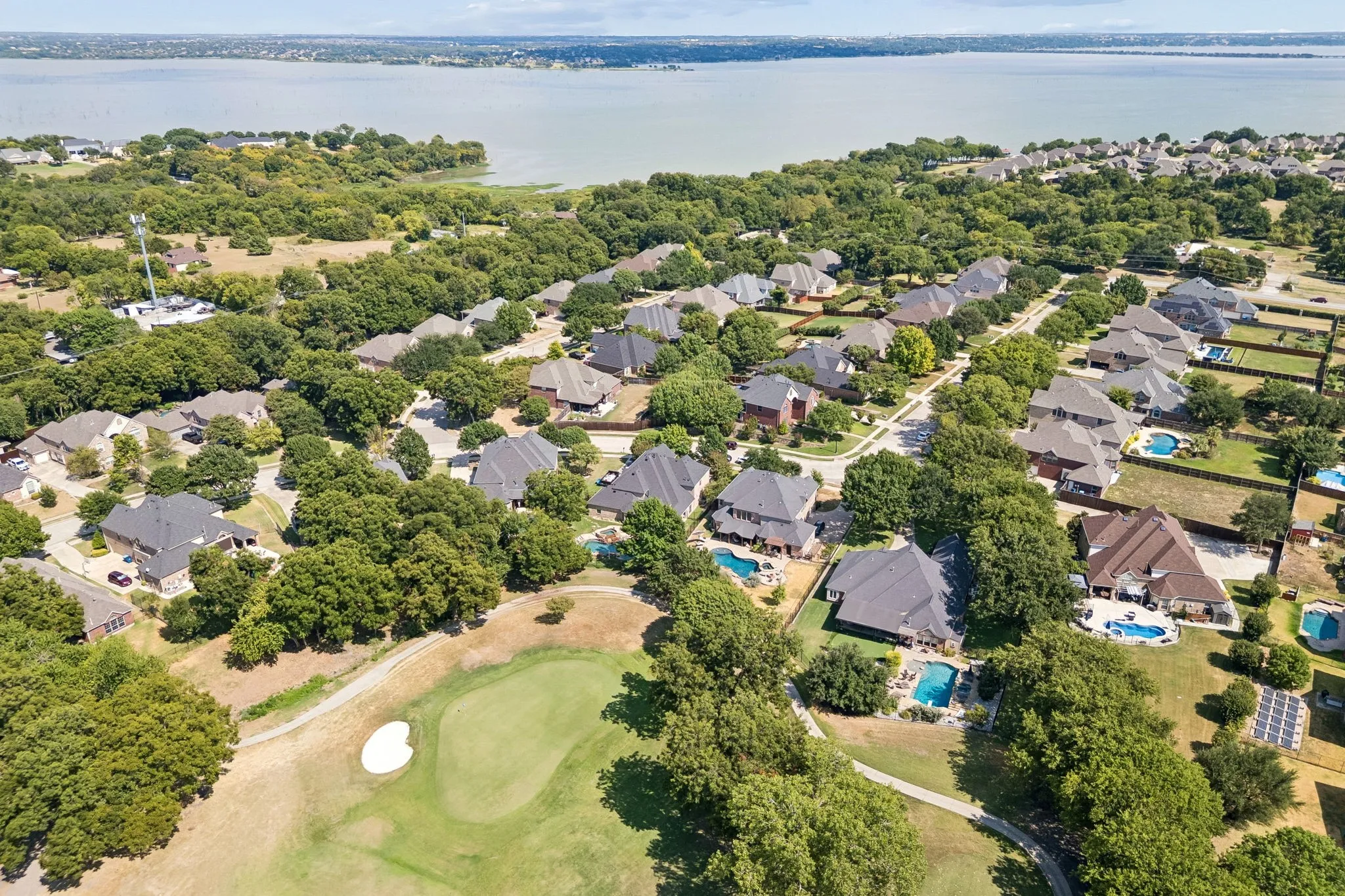 Waterview from Above - An aerial perspective showcases the neighborhood’s distinctive setting, with the Waterview Golf Course winding through the community and Lake Ray Hubbard stretching across the horizon.