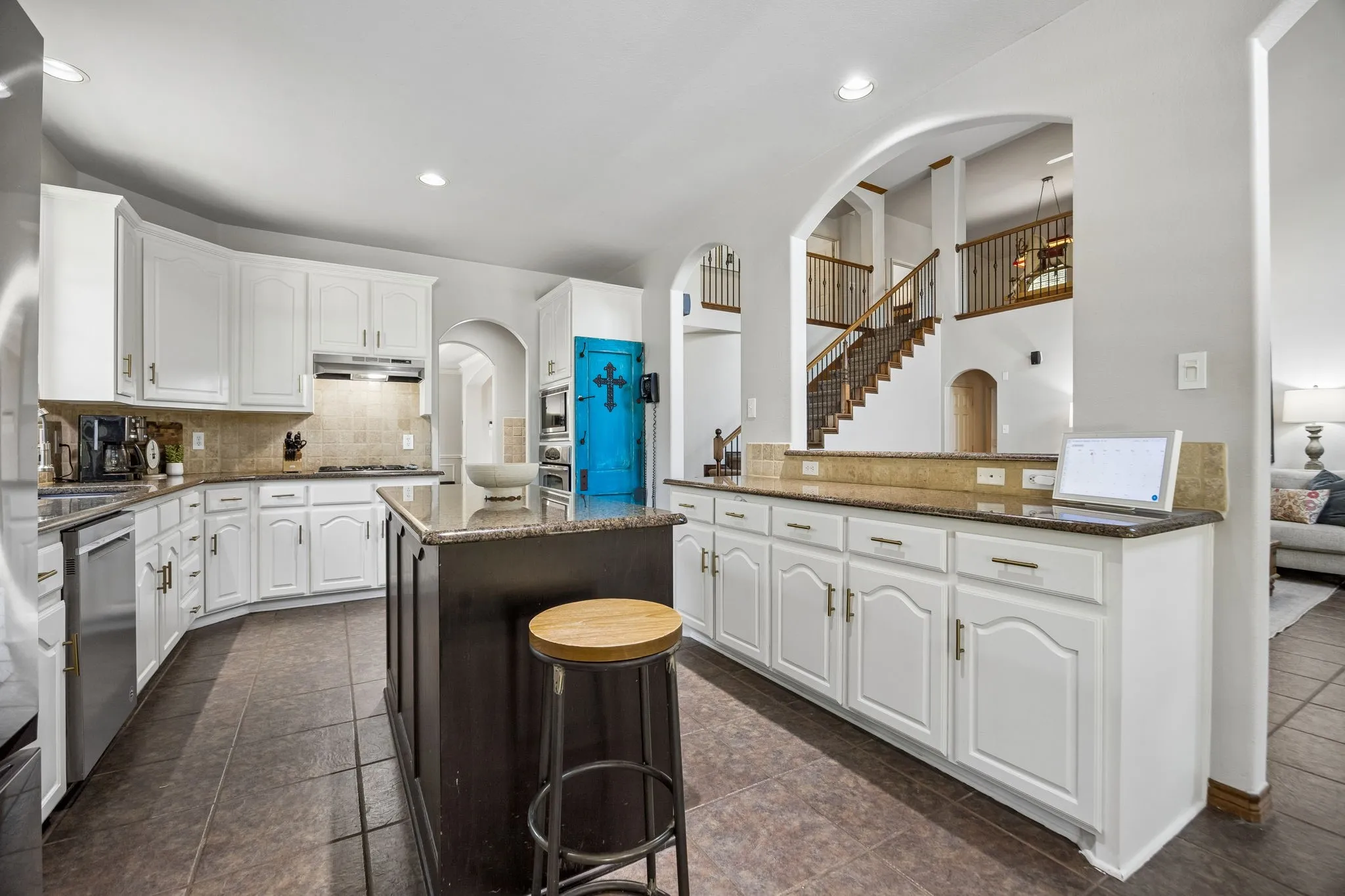 Kitchen Built for a Crowd - Two islands, extensive granite workspace, abundant cabinetry and open sightlines into the family room make this kitchen especially functional for everyday cooking, entertaining and serving.