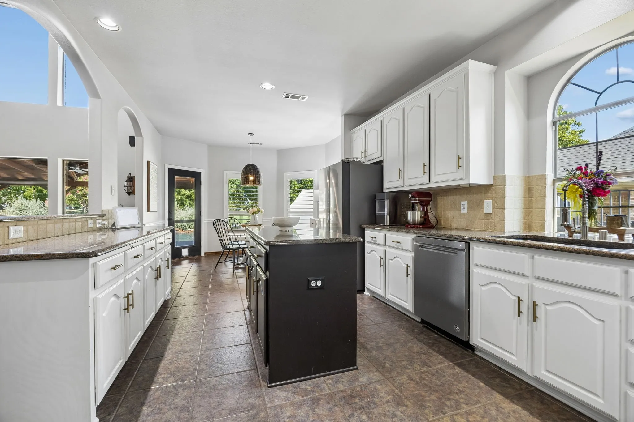 A Kitchen with Serious Workspace - The double-island kitchen provides extensive granite work surfaces, abundant cabinetry and stainless appliances, creating multiple zones for prep, serving and everyday meals.