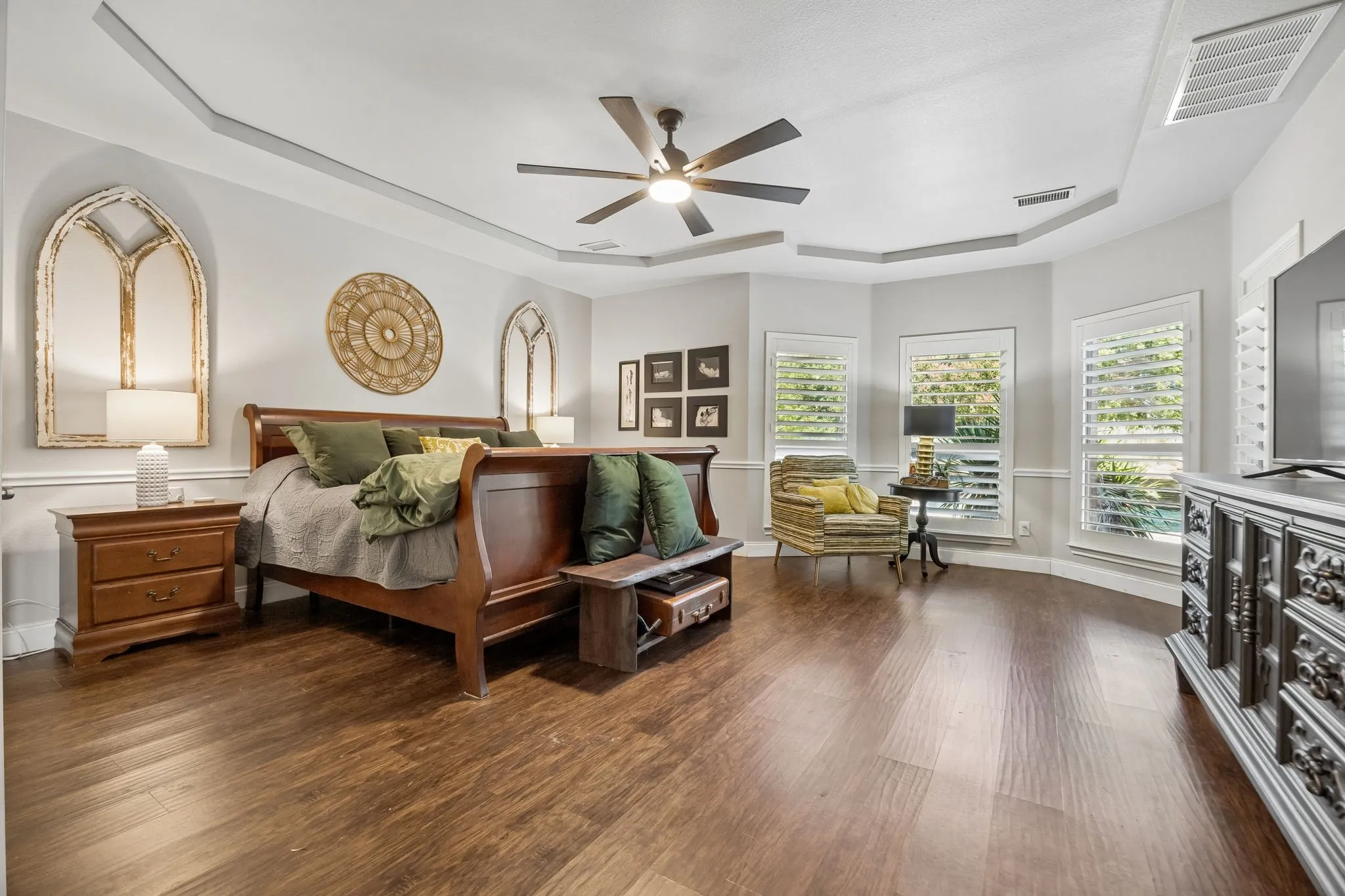 A Primary Suite with Room to Unwind - Generous dimensions, a tray ceiling and a dedicated sitting area create a true owner’s retreat, with multiple windows bringing in natural light and views toward the backyard.